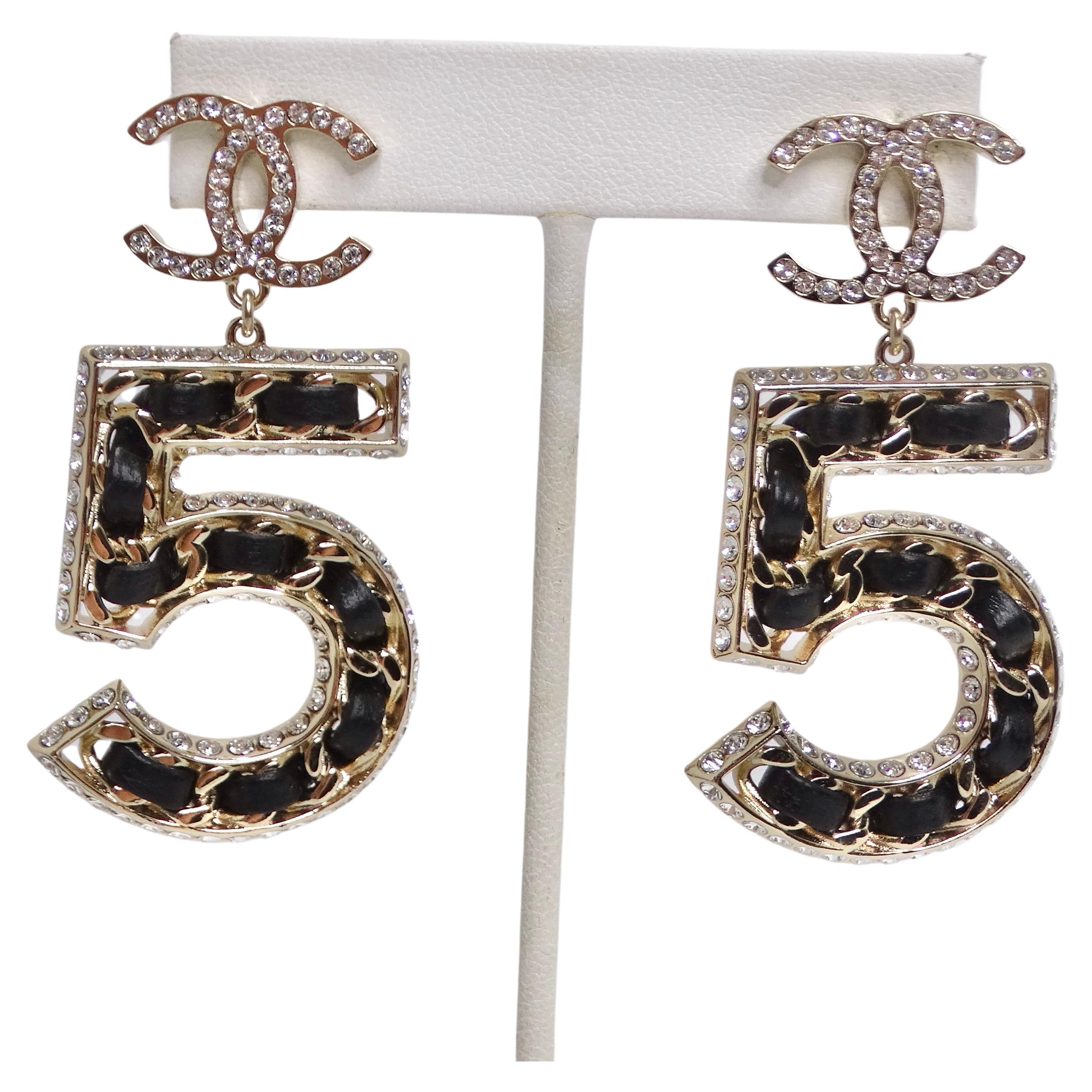 Introducing the Chanel 2023 Crystal Lambskin Chain CC No. 5 Drop Earrings, the epitome of luxury and sophistication! These exquisite earrings are the perfect accessory to elevate your style and make a bold fashion statement. These earrings feature