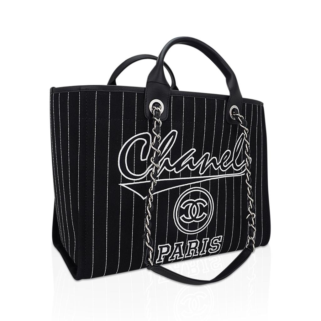 Guaranteed authentic Chanel 2023 large Deauville shopping tote featured in Black with white striping.
From the Spring Summer 2023 Collection by Virginie Viard.
Striped with Chanel and interlocking CC on front the font is reminiscent of summer and