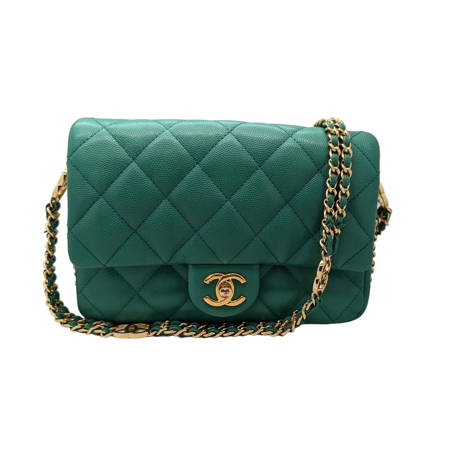 From the Chanel Cruise 2023 Classic Bag Collection. This chic bag is crafted of quilted caviar leather in green. It features a polished gold chain link leather threaded shoulder strap and a facing gold Chanel CC turn lock. This flap opens to a green