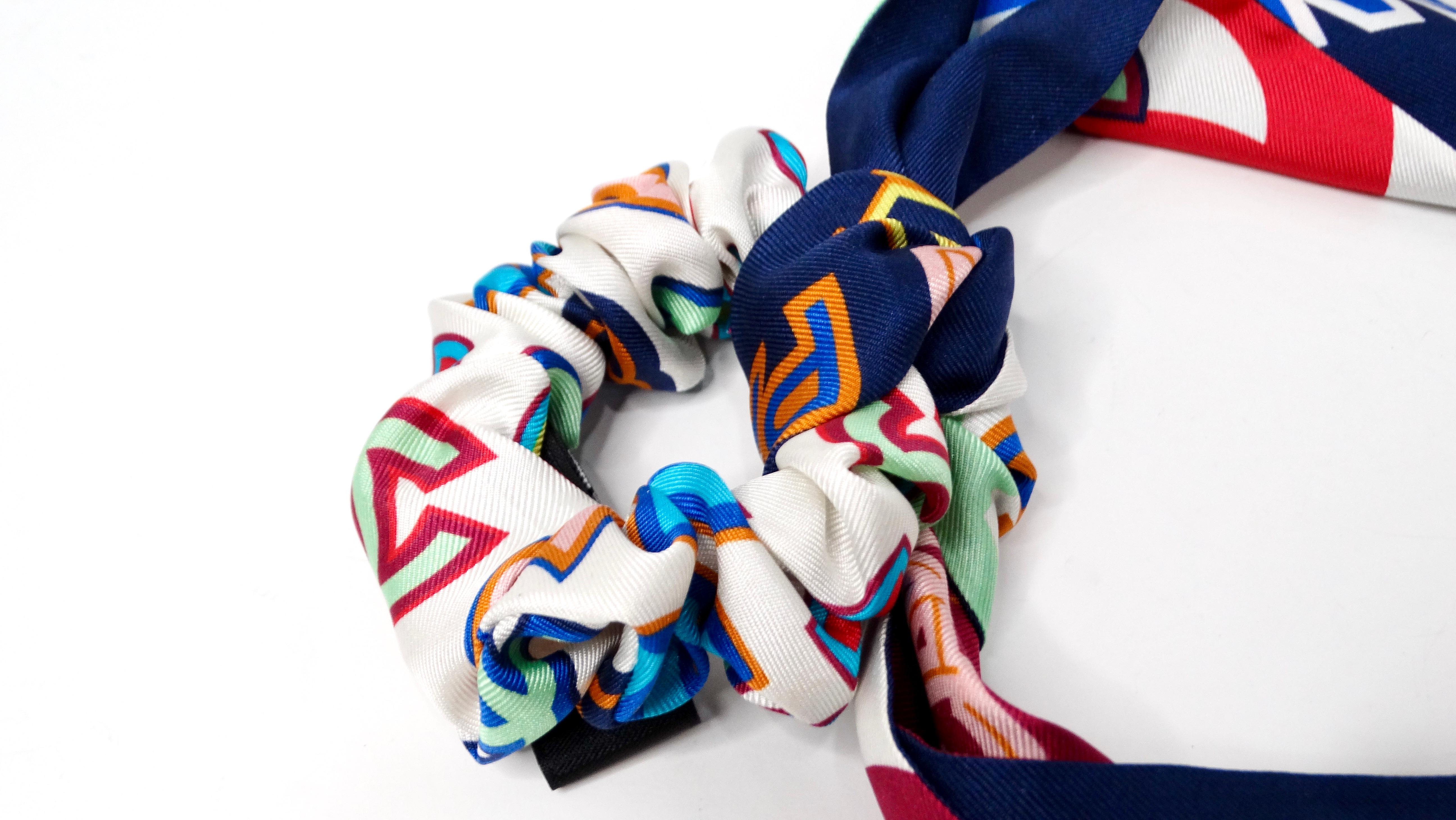 The Chanel 2023 Multicolor 31 Cambon Silk Twill Hair Tie is a luxurious accessory that epitomizes sophistication and style. Crafted from high-quality silk, this hair tie features a vibrant blend of colors, including crisp white, playful pink,