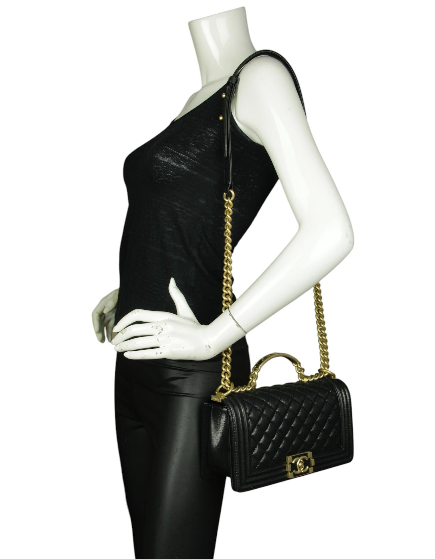 Chanel 2024 Black Caviar Quilted Medium Top Handle Boy Bag   

Made In: France
Year of Production: 2024
Color: Black
Hardware: Goldtone
Materials: Caviar leather
Lining: Leather
Closure/Opening: Flap top with pushlock
Exterior Pockets: None
Interior
