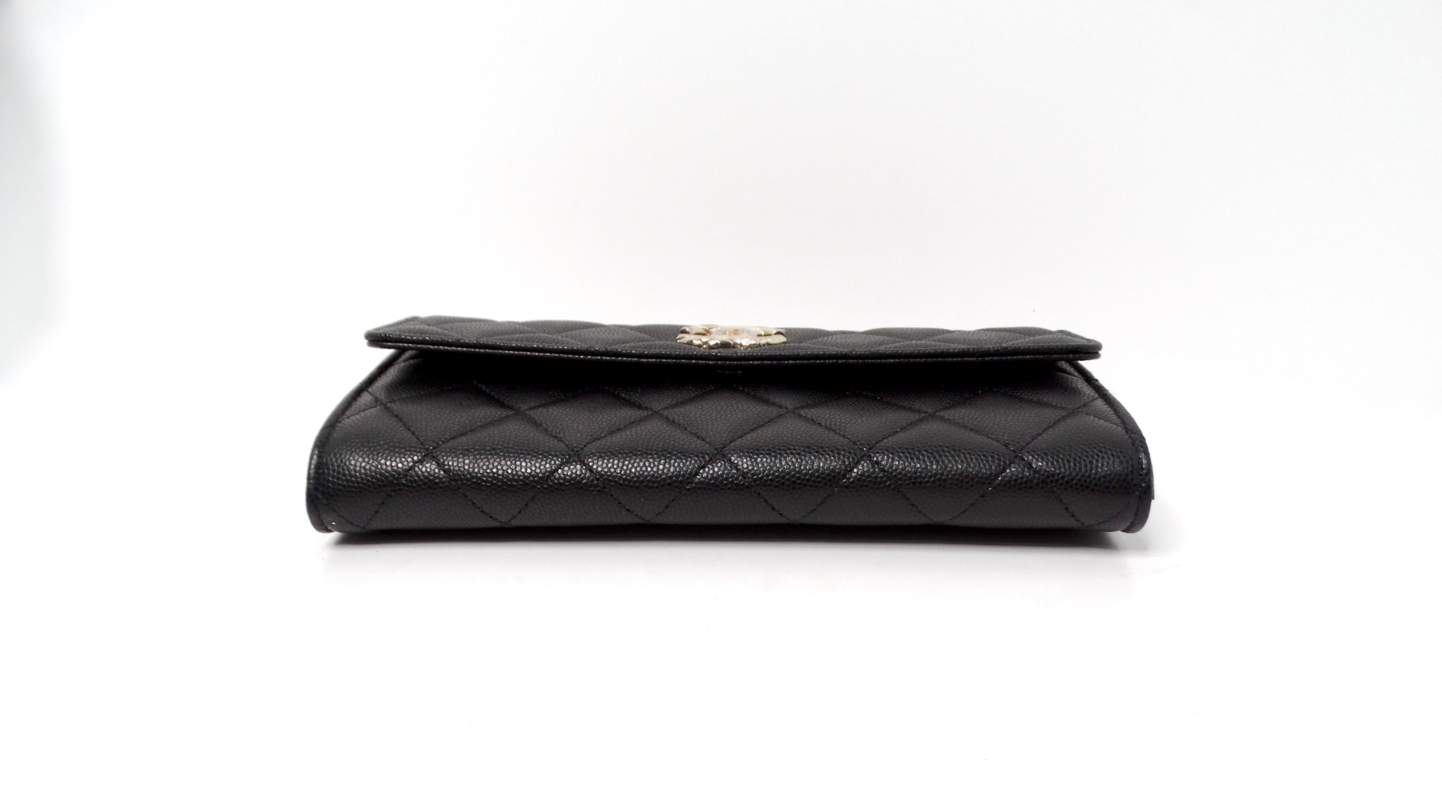 The Chanel 2024 Black Caviar Quilted Leather Long Flap Wallet is a stunning accessory that combines luxury with practicality. Crafted from premium caviar leather, this wallet boasts a rich texture and exceptional durability, making it a perfect