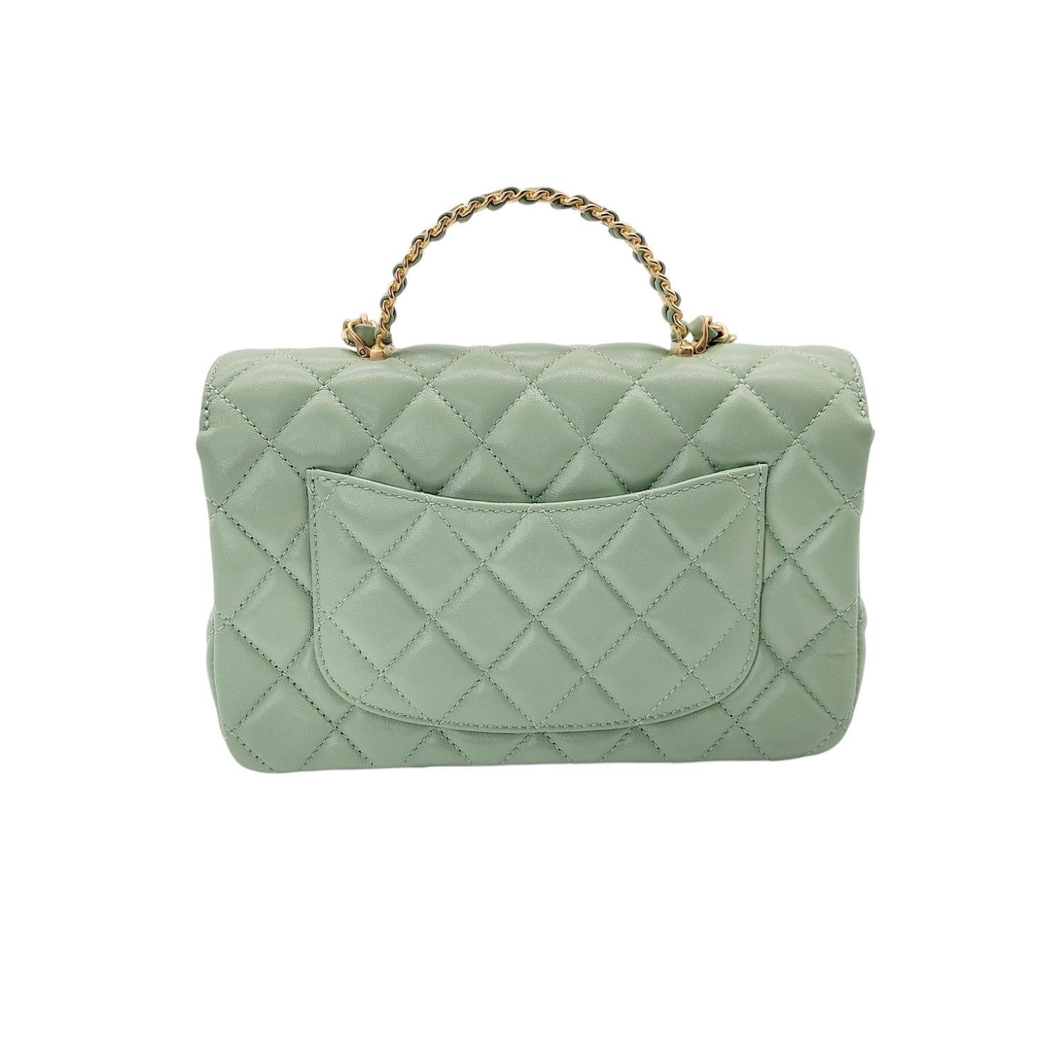 From the Cruise 2024 Collection. This chic mini crossbody classic is crafted in quilted lambskin leather in light green. The bag features a leather threaded gold chain Chanel logo top handle lined with crystals, a gold chain link leather threaded