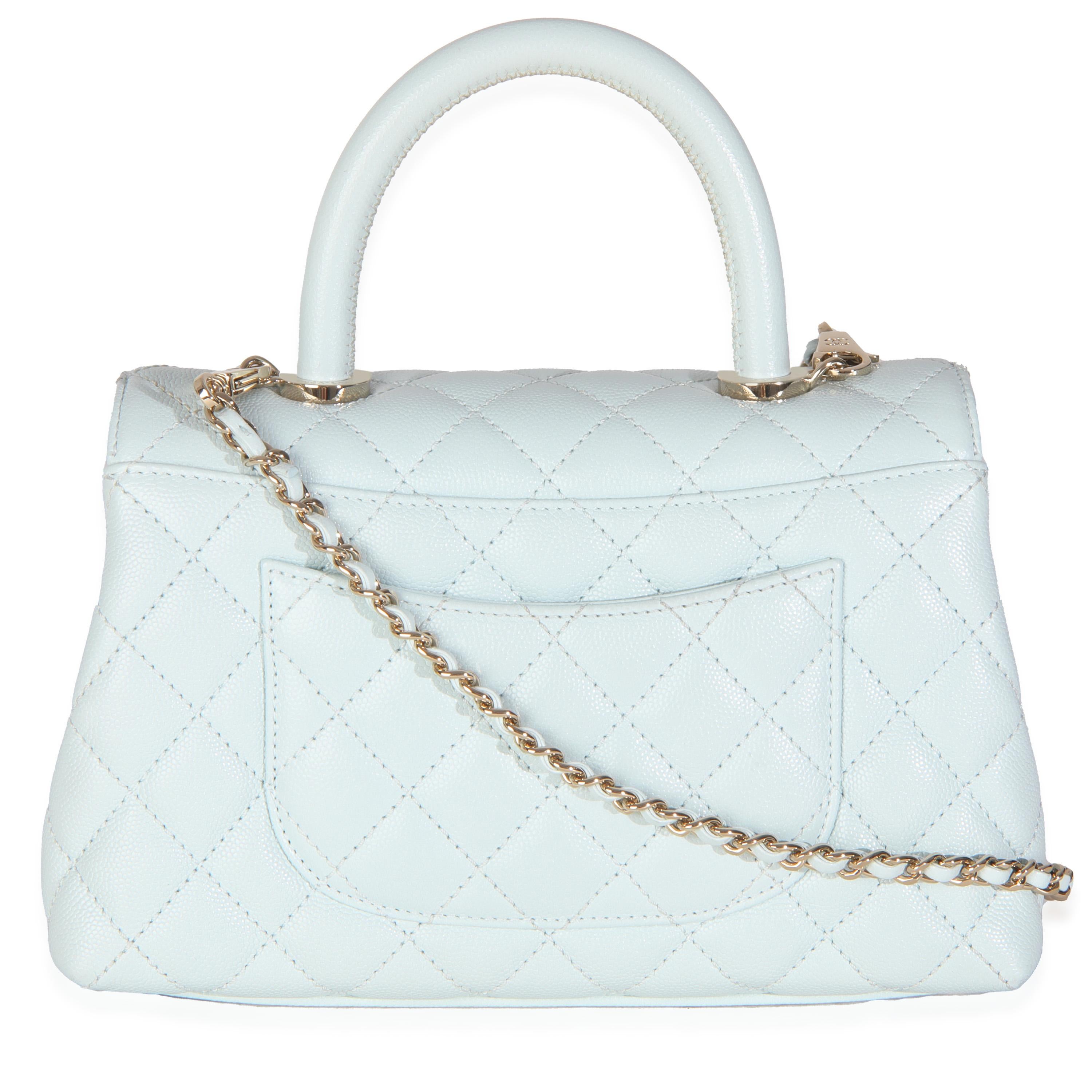 Listing Title: Chanel 21K Blue Quilted Caviar Mini Coco Handle Flap Bag
SKU: 145723
MSRP: 6200.00 USD
Condition: Pre-owned 
Condition Description: A timeless classic that never goes out of style, the flap bag from Chanel dates back to 1955 and has