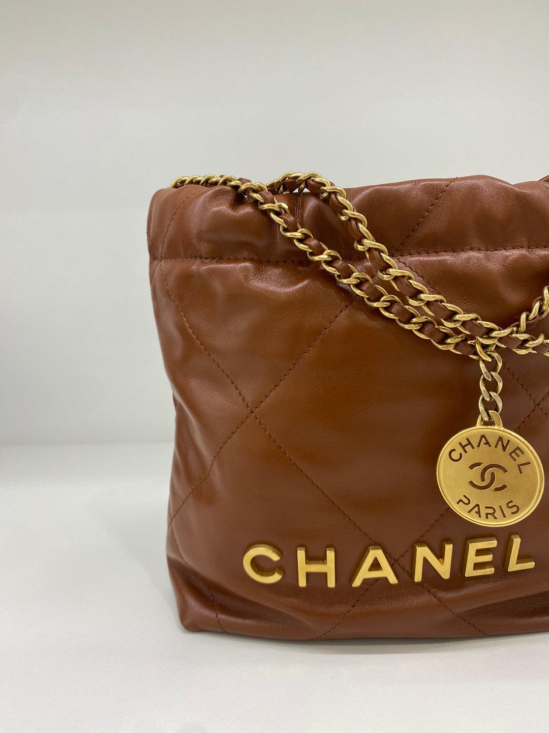 This elegant Chanel 22 Bag Mini is a timeless and classic piece, crafted from the finest quilted leather. Its timeless silhouette will take you from day to night, adding a touch of sophistication to any ensemble. With its signature gold hardware,