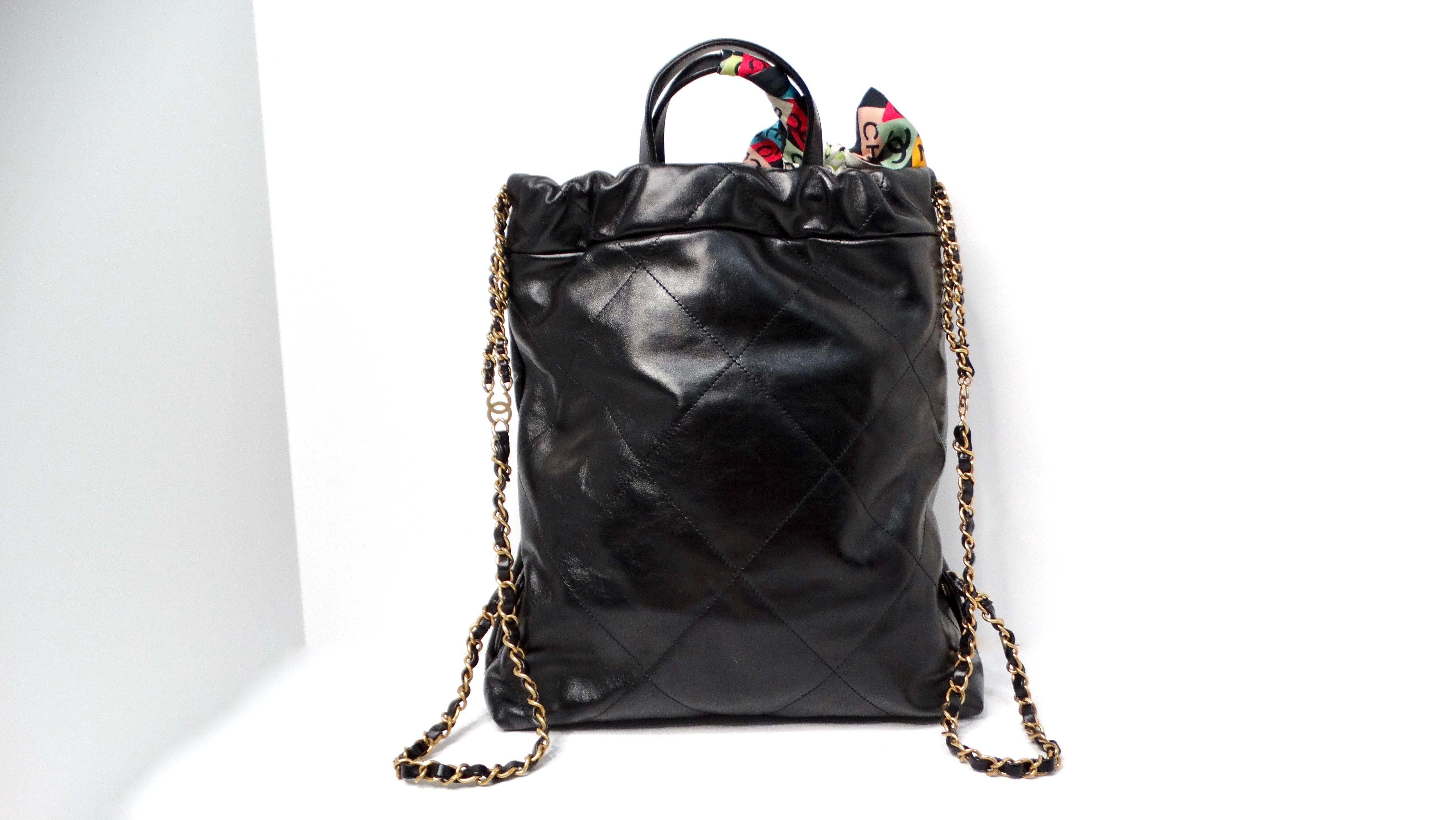 The Chanel 22 Black Shiny Calfskin Backpack with Gold-Tone Hardware & Twill is a stunning reinterpretation of the iconic 22 bag launched in 2022. This sleek backpack encapsulates a perfect blend of luxury and functionality, crafted from high-quality