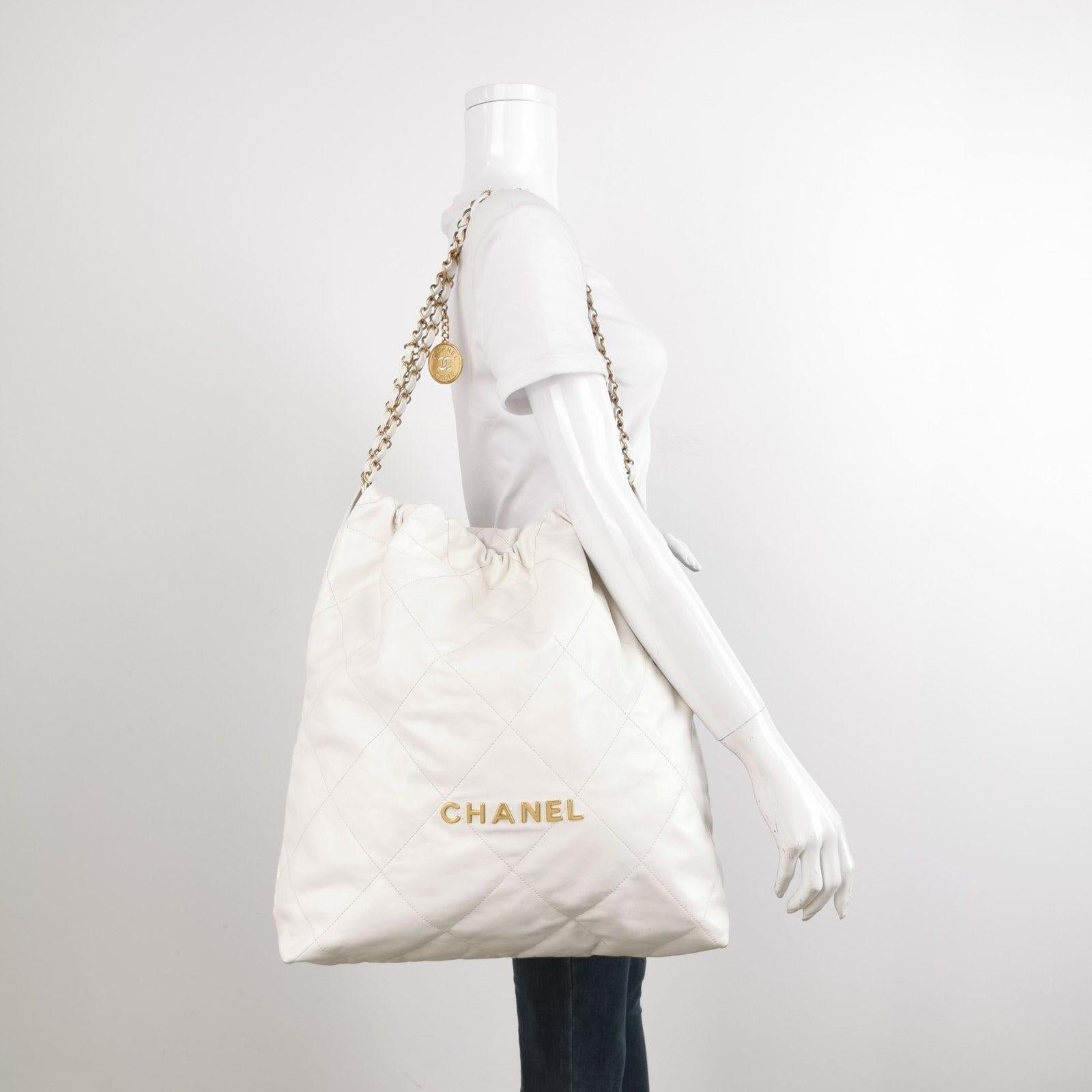 Chanel 22 Hobo Bag Medium Shiny Calfskin Leather White with Gold-tone Hardware These are professional photos of the actual bag. The Chanel 22 Bag, named after its year of release, has taken the fashion world by storm with its latest design from