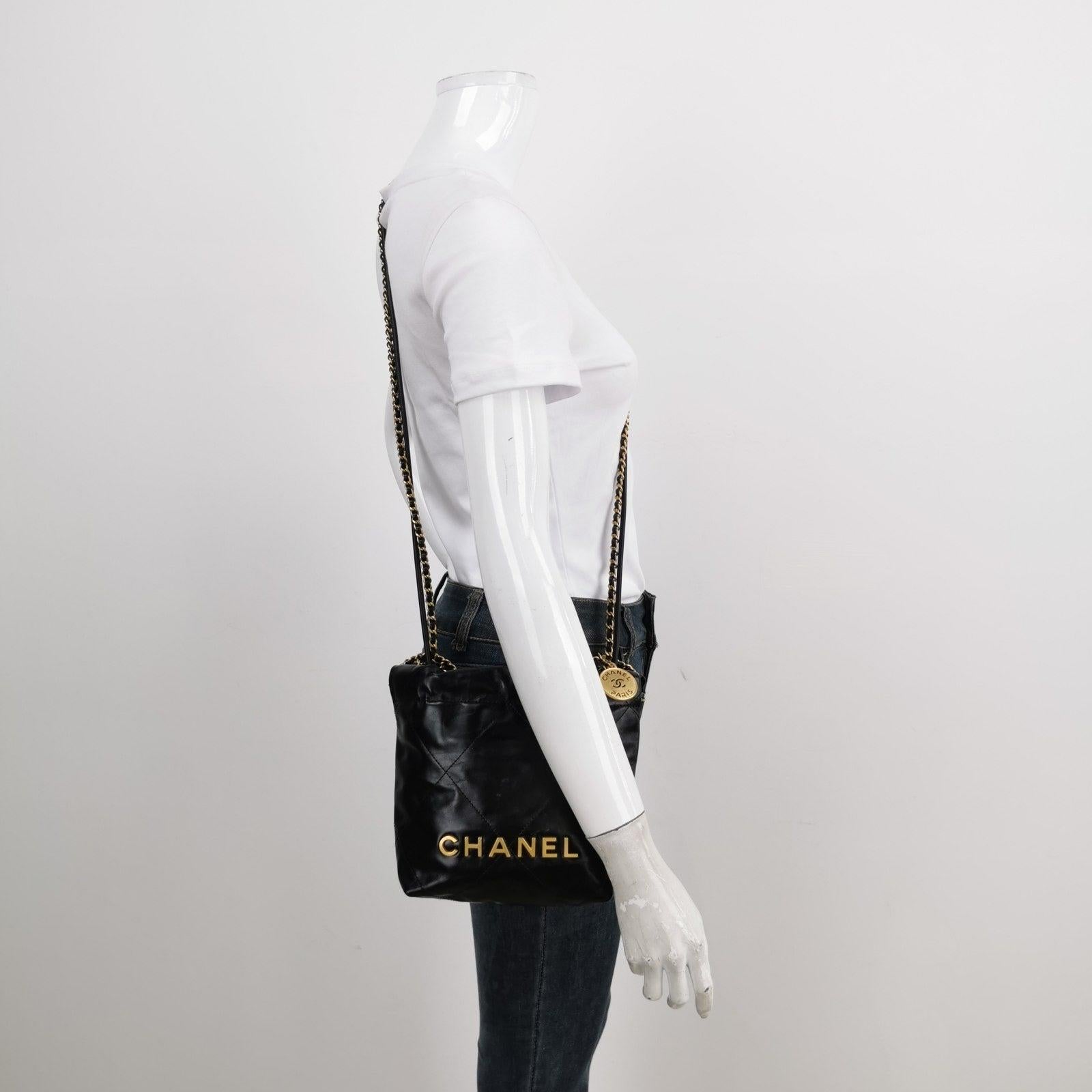 Chanel 22 Hobo Bag Mini Shiny Calfskin Leather Black with Gold-tone Hardware These are professional photos of the actual bag. The Chanel 22 Bag, named after its year of release, has taken the fashion world by storm with its latest design from