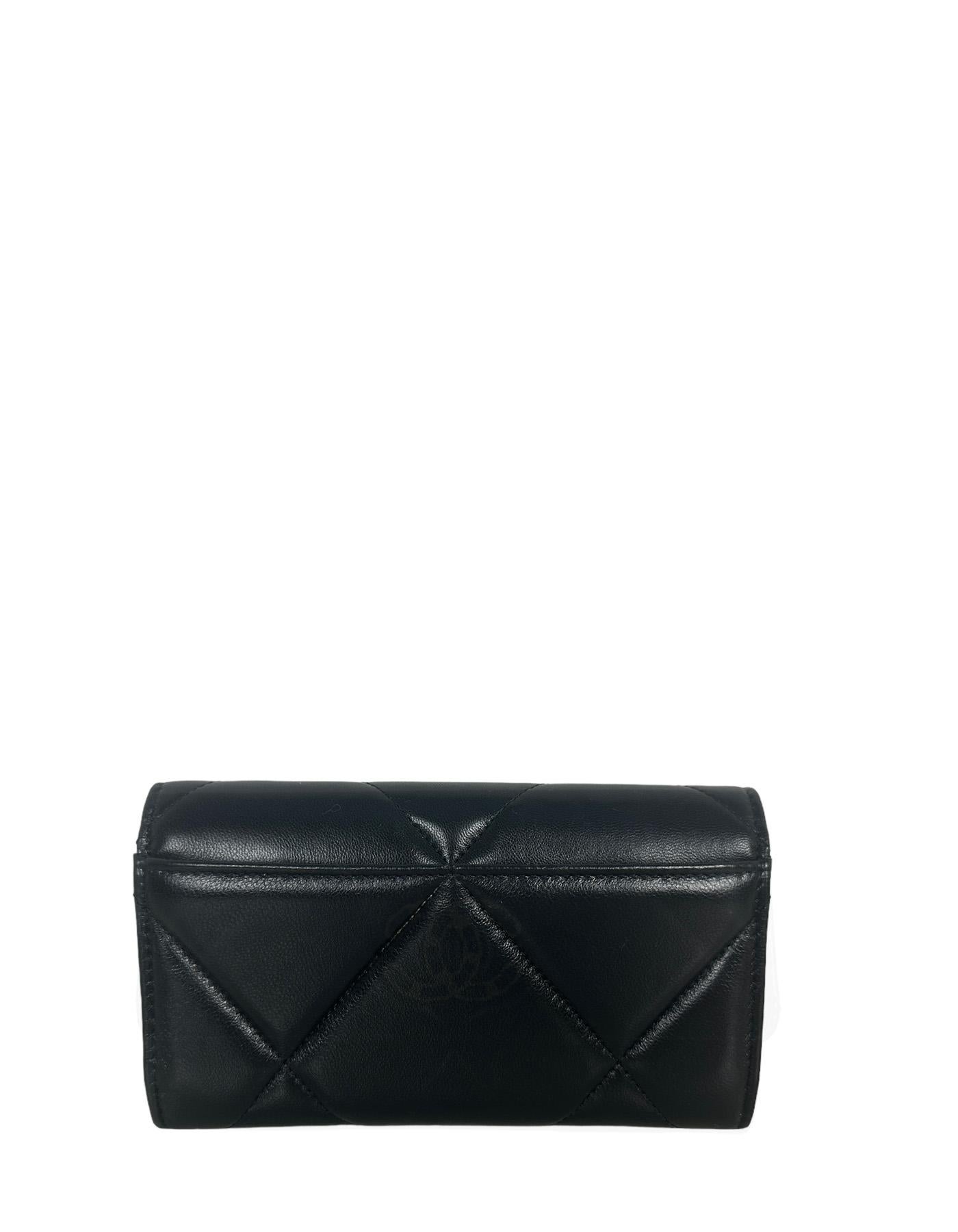 Chanel '23 NEW Black Lambskin Leather Quilted Chanel 19 Flap Wallet

Made In: Spain
Color: Black
Hardware: Goldtone
Materials: Lambskin leather
Lining: Leather and grosgrain
Outer pockets: Back slit
Interior Pockets: Credit card slots and zip coin