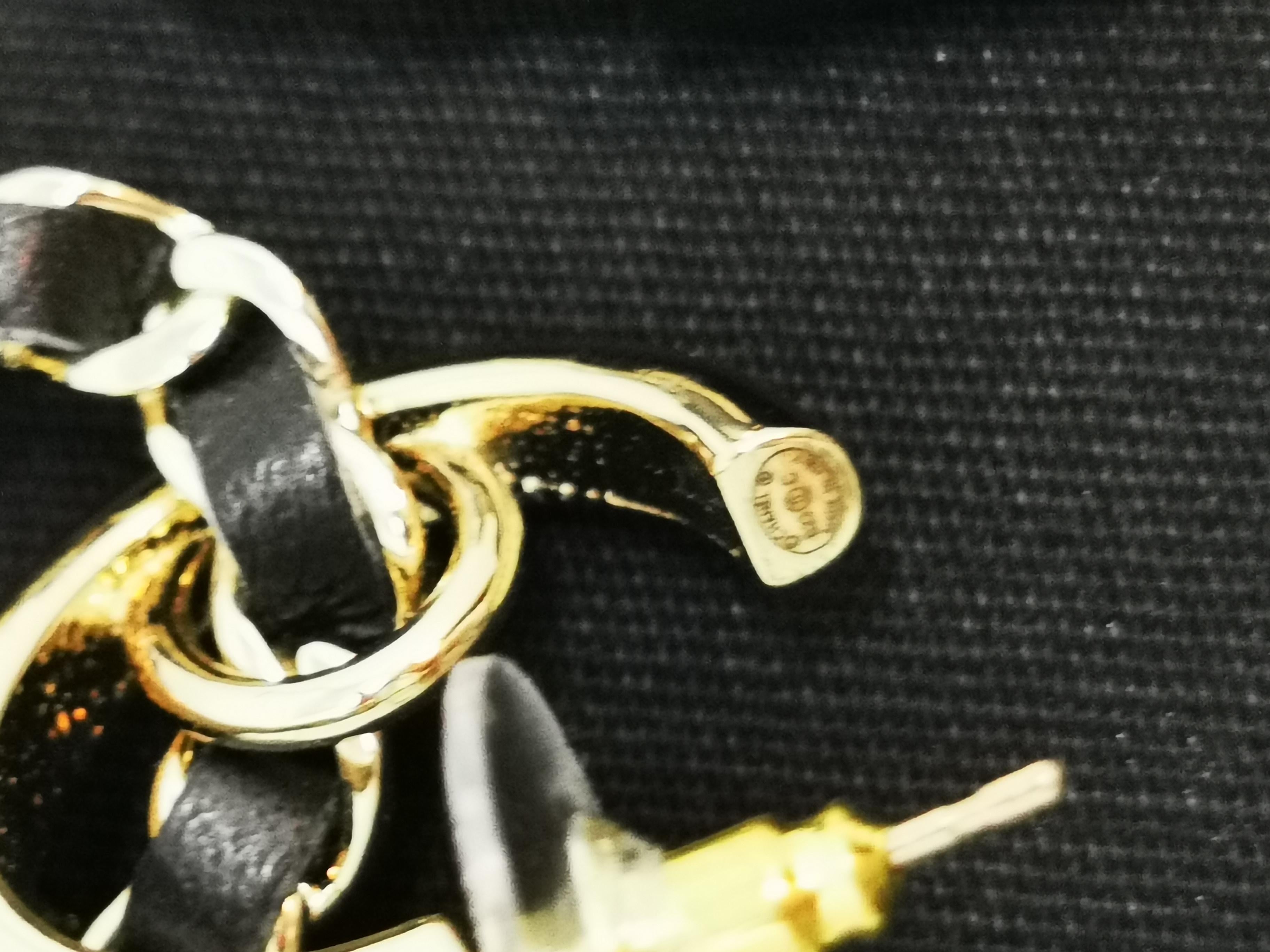 Add a touch of playful sophistication to your jewelry collection with these stunning Chanel earrings from the 23C collection. Designed to capture the brand's iconic style, these earrings feature gold-tone hoops adorned with a chic dangling charm