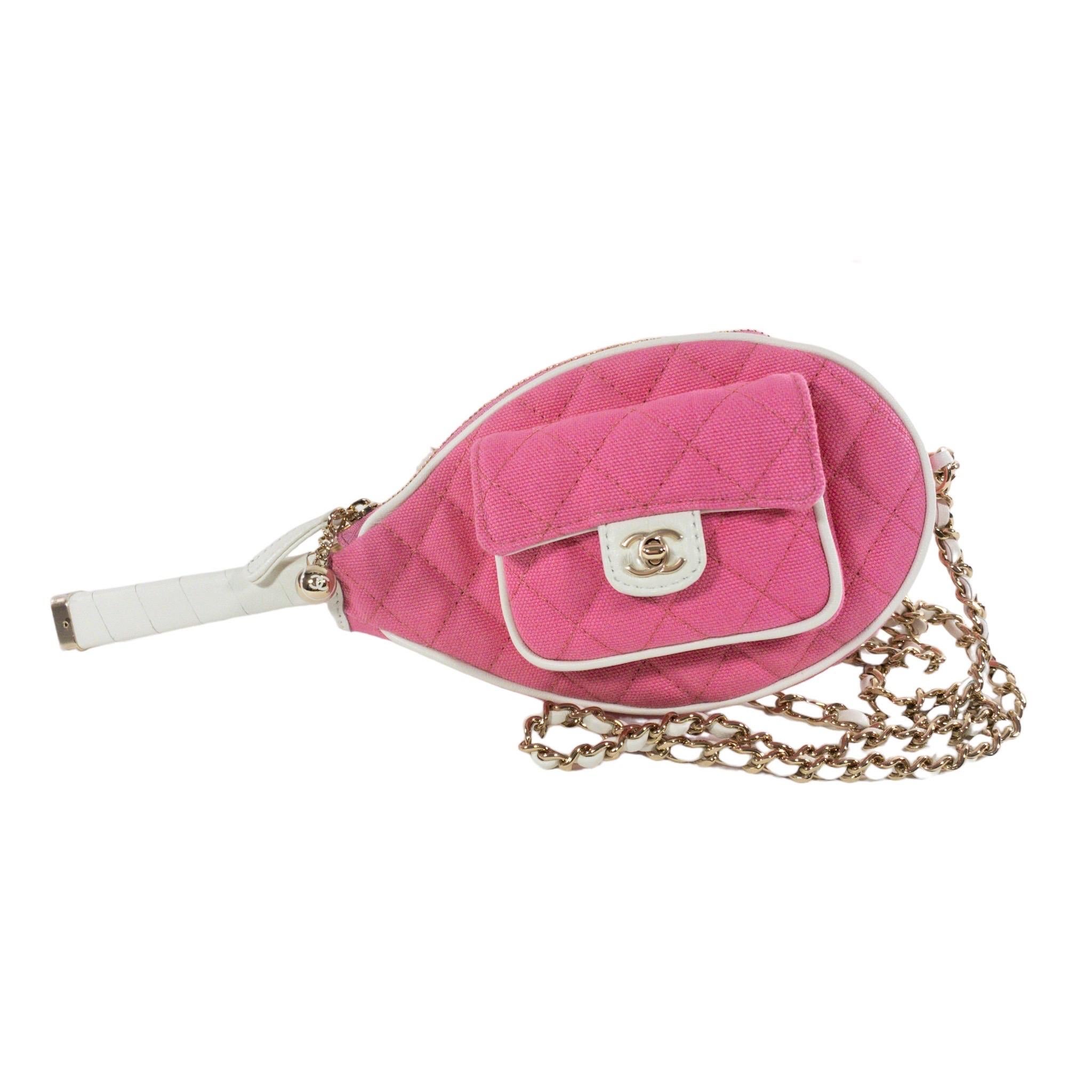 Consign of the Times presents this unique and authentic Chanel Tennis Racket Hand Mirror Case. Pink quilted fabric exterior with white leather trim. Small flap pocket in front with CC turn clasp, zipper at top. Wooden hand mirror inside in the shape