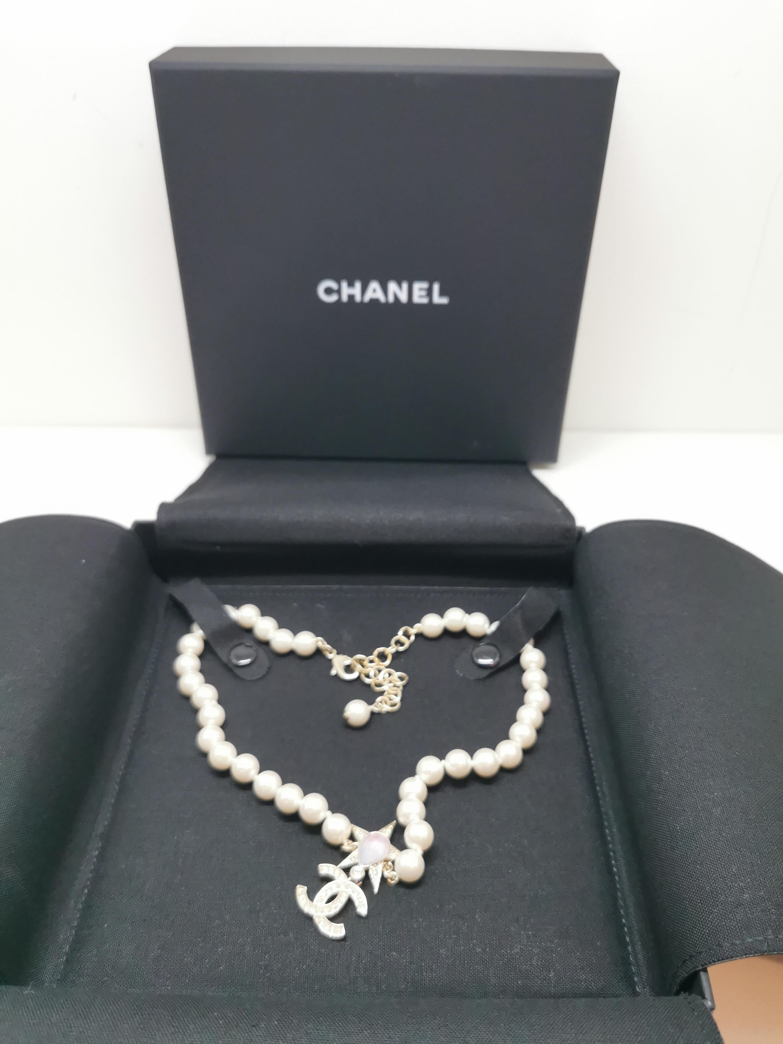 Elevate your style with this exquisite Chanel pearl choker, a standout piece from the coveted 23P collection. This timeless yet contemporary accessory features a strand of lustrous faux pearls, meticulously crafted to exude sophistication and