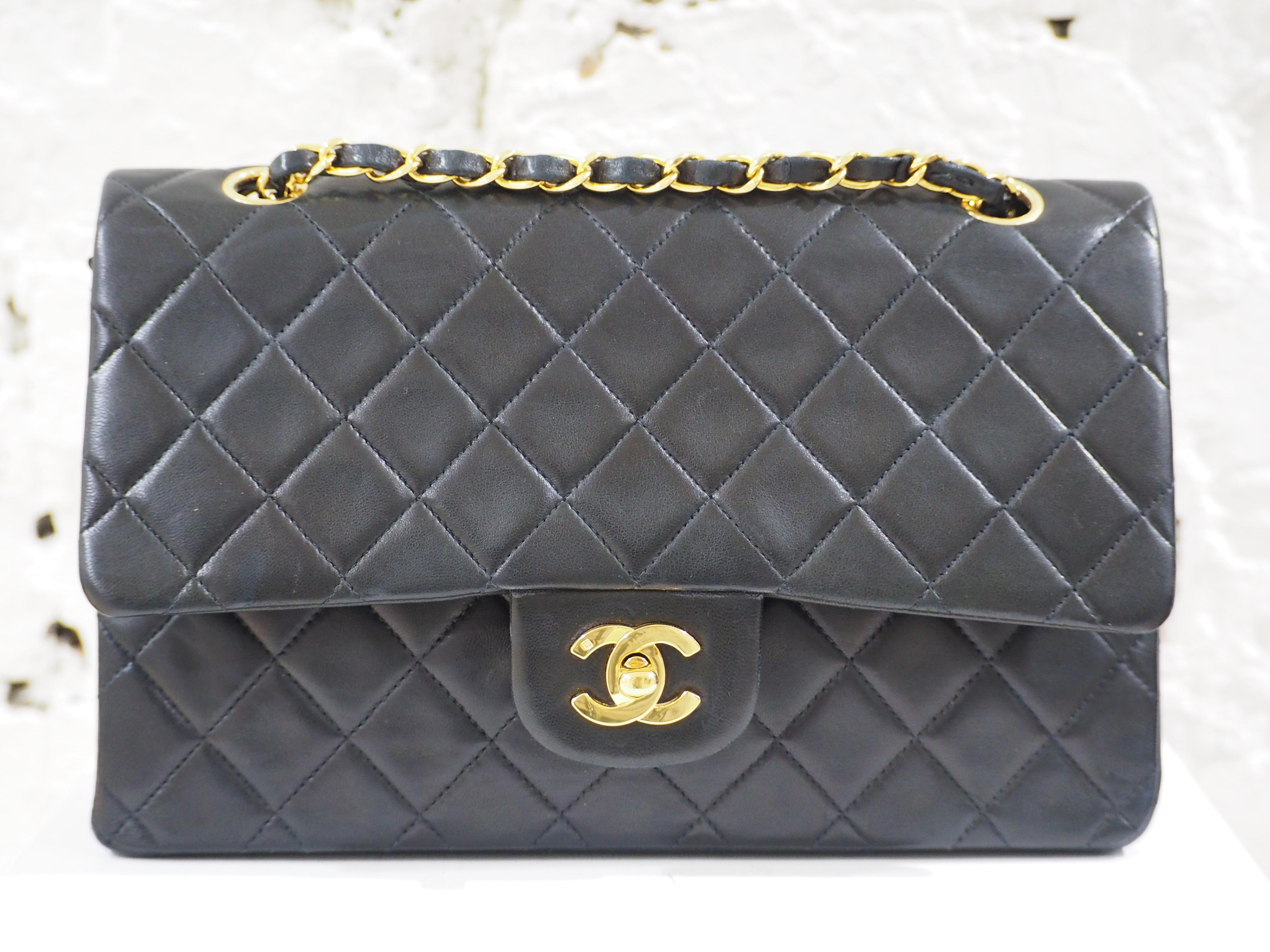 Chanel 2.55 black leather shoulder bag
gold tone chain and cc logo