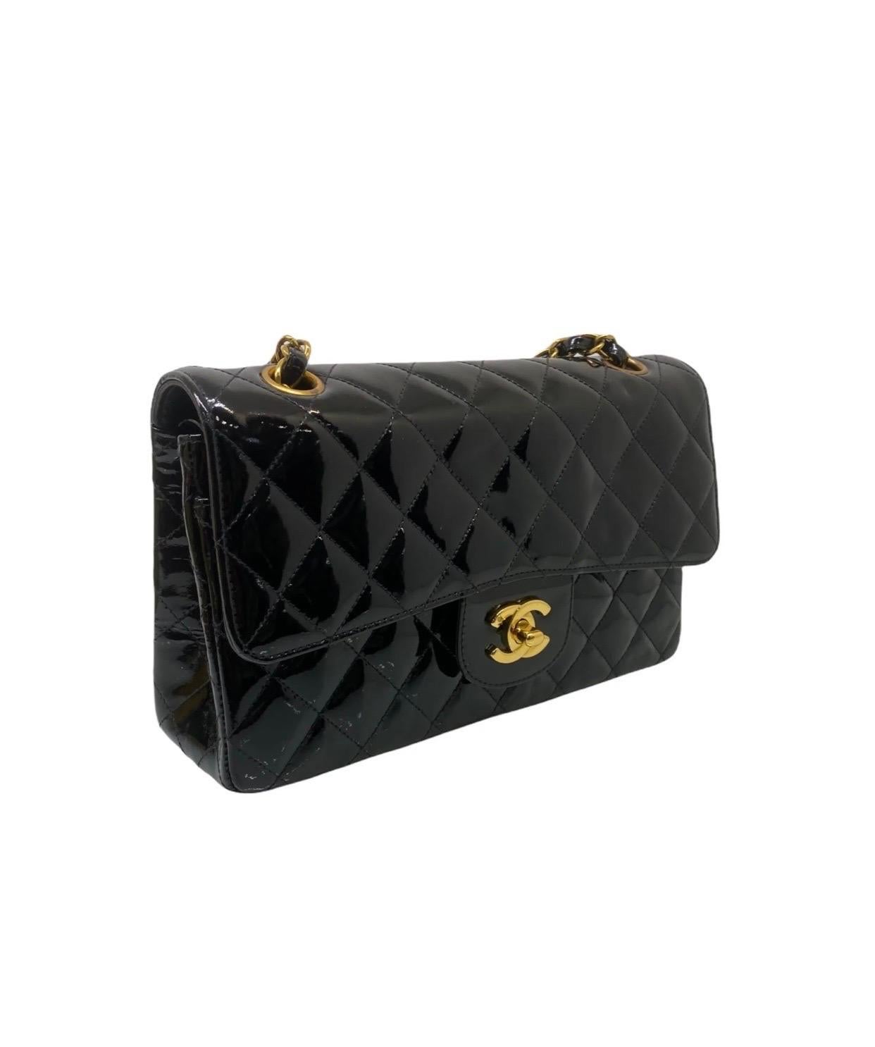 Chanel signed bag, model 2.55, year of production 1994-1996, made of black patent leather with gold hardware.

It has two front flaps, one with a twist lock and one inside with a button closure.

Internally lined in black leather, complete with