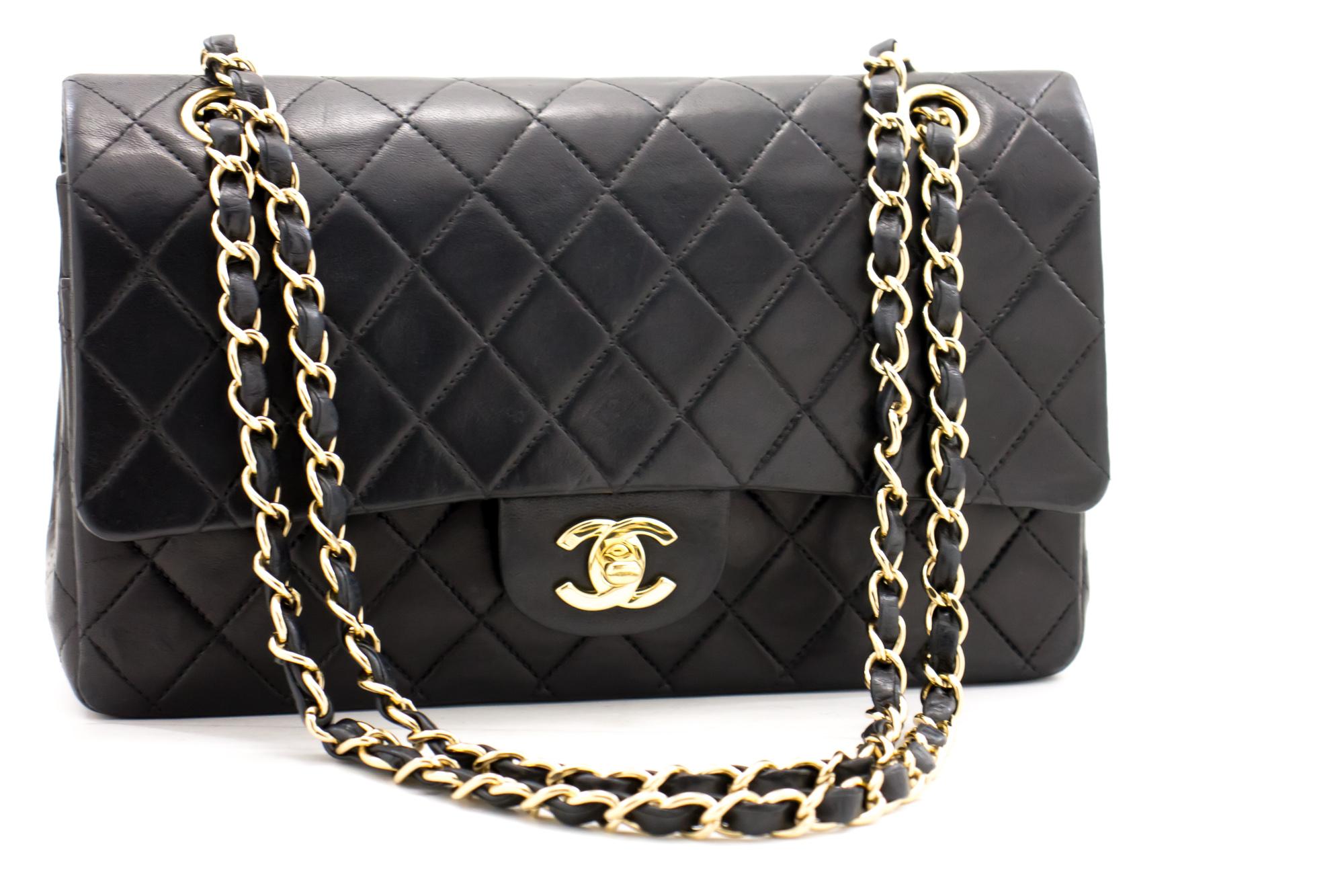 An authentic CHANEL 2.55 Classic Double Flap Medium Chain Shoulder Bag Black made of black Lambskin. The color is Black. The outside material is Leather. The pattern is Solid. This item is Contemporary. The year of manufacture would be 2 0 0 2