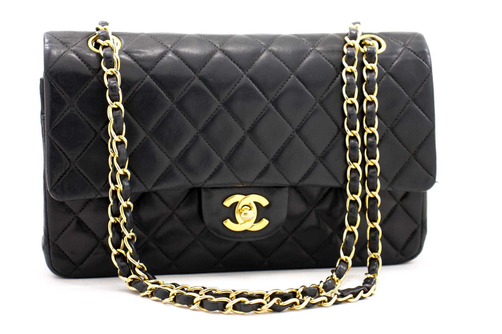 An authentic CHANEL 2.55 Classic Double Flap Medium Chain Shoulder Bag Black made of black Lambskin. The color is Black. The outside material is Leather. The pattern is Solid. This item is Contemporary. The year of manufacture would be 2000-2 0 0 2