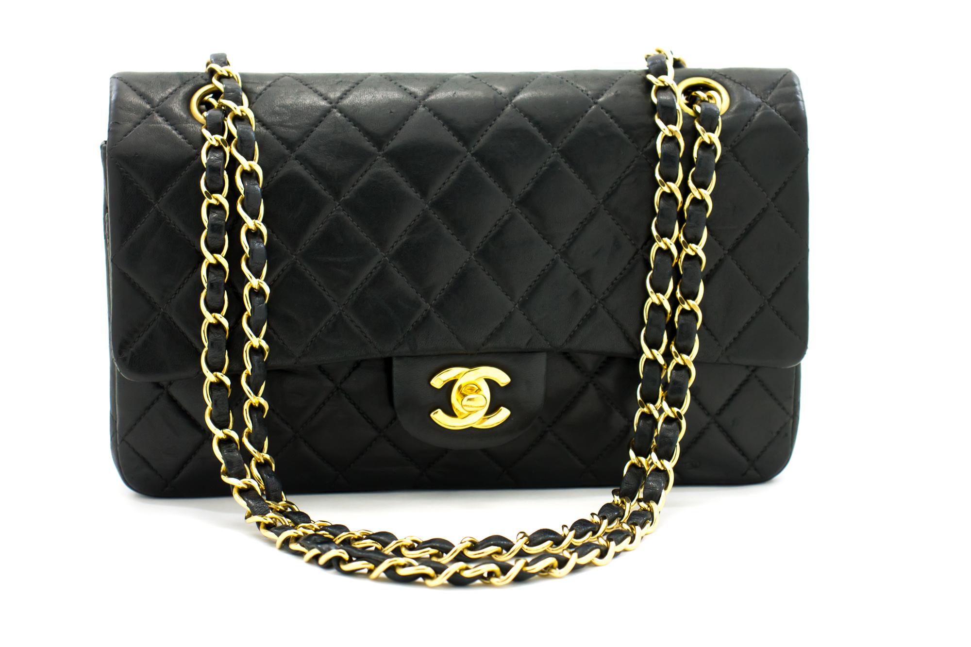 An authentic CHANEL 2.55 Classic Double Flap Medium Chain Shoulder Bag Black made of black Lambskin. The color is Black. The outside material is Leather. The pattern is Solid. This item is Vintage / Classic. The year of manufacture would be 2000-2 0