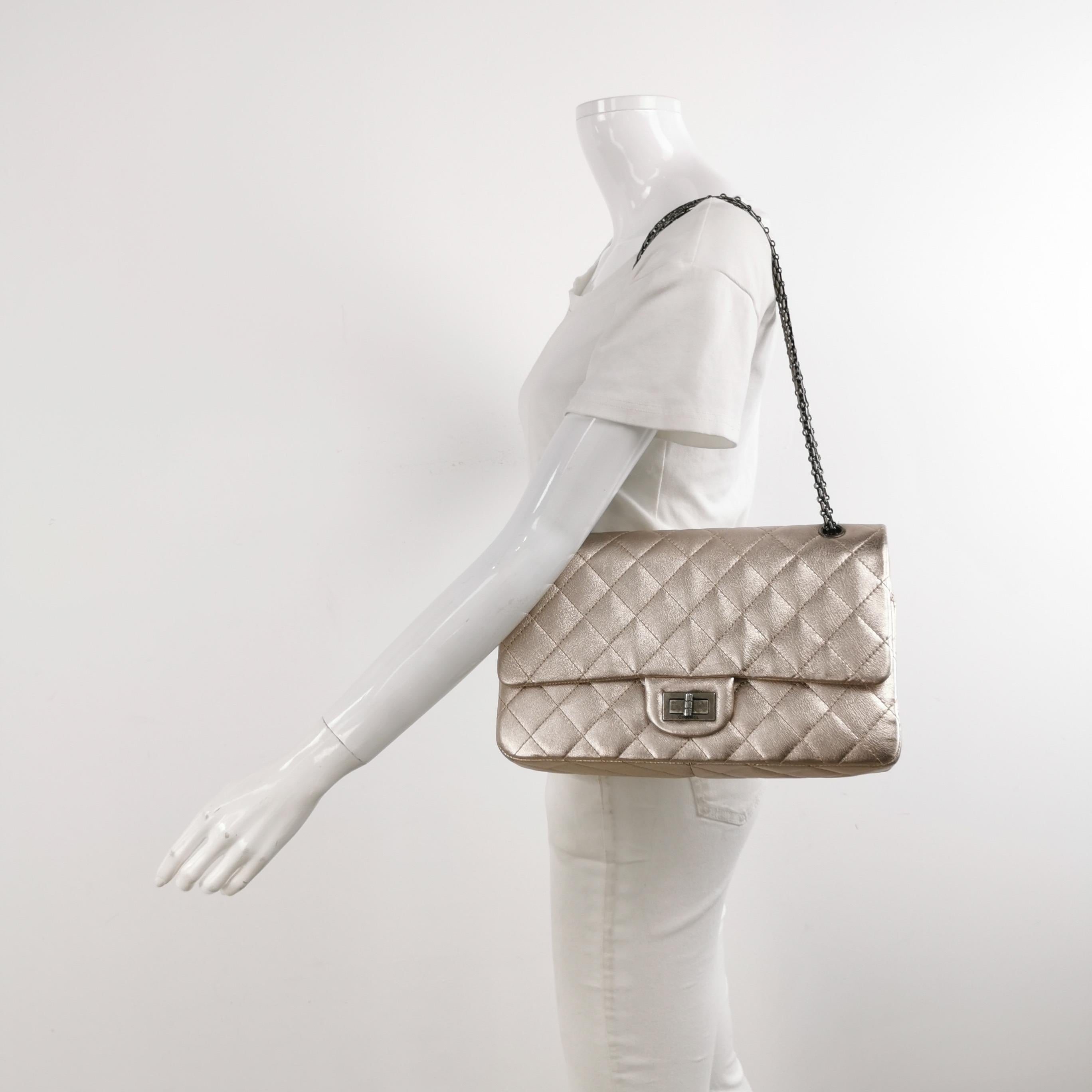 This Chanel 2.55 Flap bag features a mademoiselle turn lock and is made of lambskin leather in a stunning rose gold / champagne with an iridescent shin, accented with silver hardware.

CONDITION: Very good condition with signs of wear throughout.