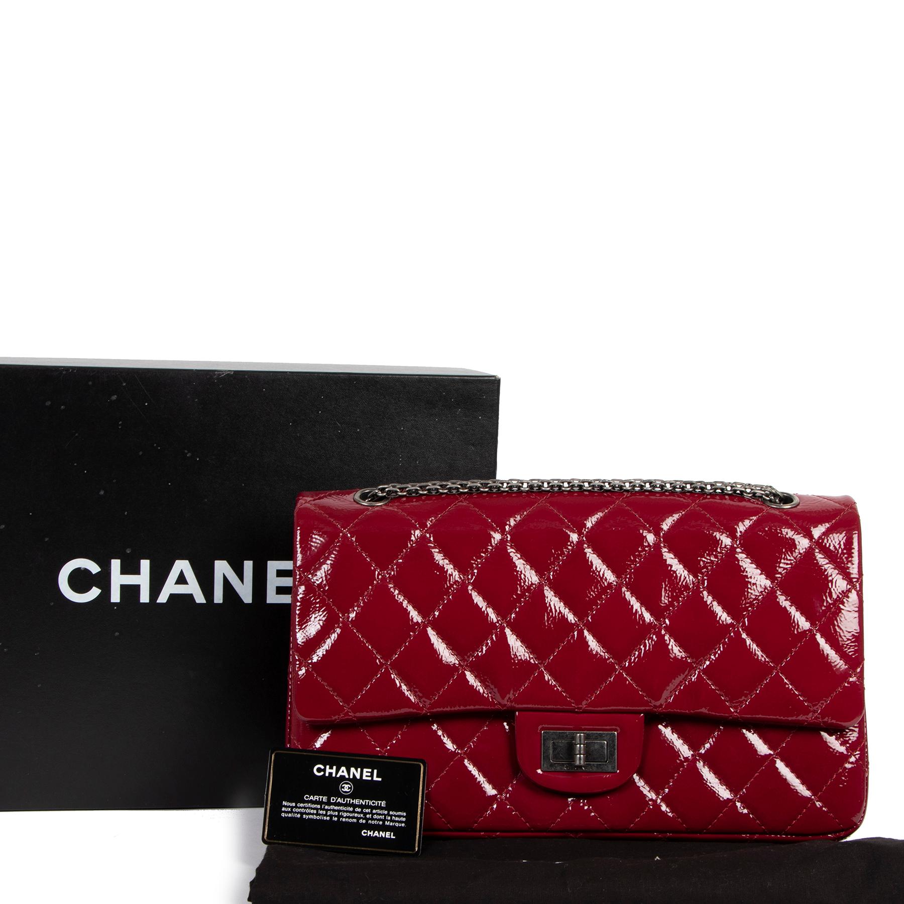 Excellent condition

Chanel 2.55 Reissue 227 Cranberry Patent Leather Bag

This gorgeous Chanel Reissue features the classic double flap design in exclusive cranberry red patent leather, finished with a dark grey chain strap and the iconic front