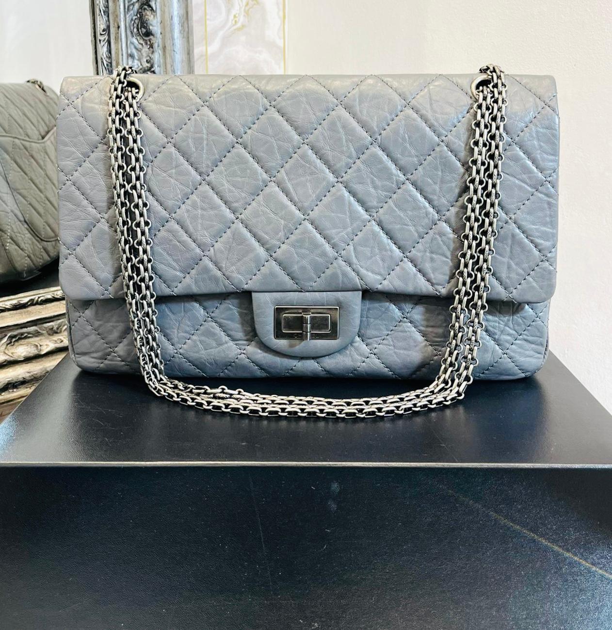 Chanel 2.55 Reissue Double Flap Leather Bag

Grey, diamond quilted handbag designed with iconic ruthenium hardware.

Featuring twist lock closure leading to magnetic double flap closure with 'CC' logo stitching detail.

Styled with shoulder chain