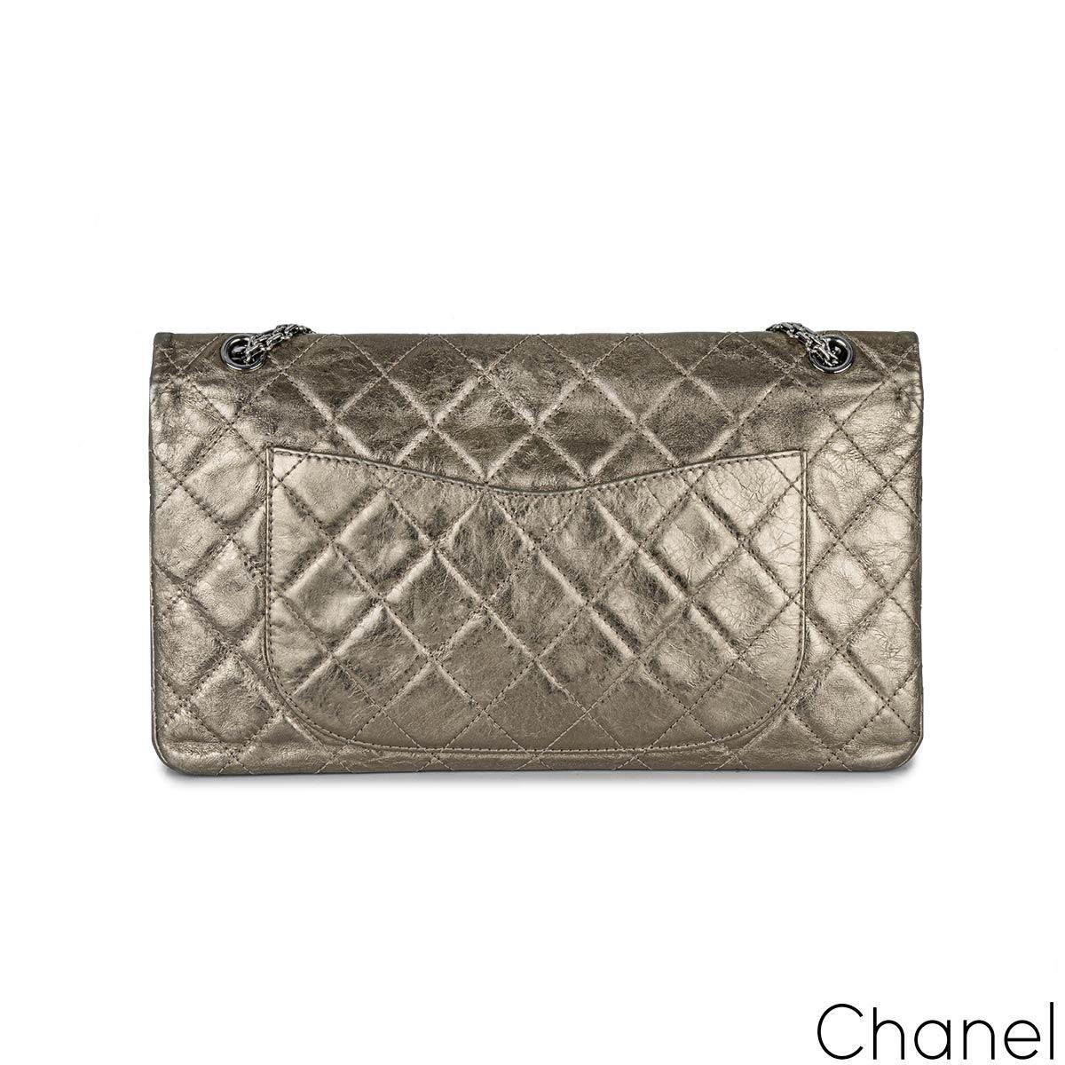 A Chic Chanel 2.55 Reissue Maxi Double Flap Handbag. The exterior of this reissue 2.55 is crafted in metallic champagne lambskin leather with signature diamond stitching and dark silver hardware. It features a front flap, a mademoiselle turn lock