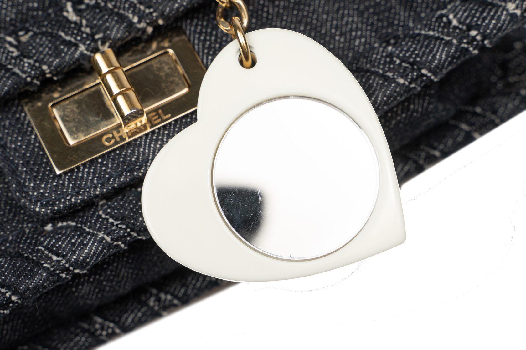 Excellent condition with few signs of use; carefully kept.
SET: dustbag, keychain in the shape of a heart with a mirror
SIZE: 21/18/5 cm
MODEL: 2.55 
Dark-blue colour
MATERIAL: Denim/Jeans
INSIDE COLOR: Beige
INSIDE MATERIAL: Beige
HARDWARE: