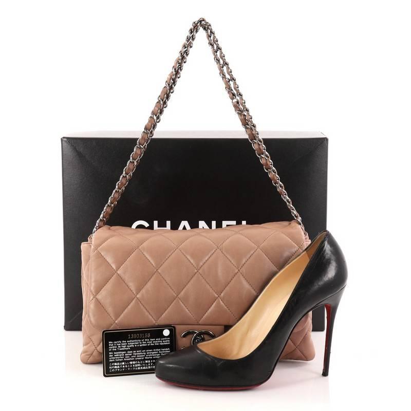 This authentic Chanel 3 Accordion Flap Bag Quilted Lambskin Jumbo is made for everyday elegance. Crafted from taupe quilted lambskin leather, this versatile accordion bag features woven-in leather chain straps, exterior back pocket, and chrome-tone