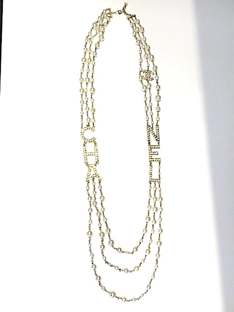 An amazing and show stopping Chanel necklace from the 2018 Vacances (Vacation) pre spring summer collection. Gold tone metal letters groups of C, H, A and N, E, L are set with crystal rhinestones along with an interlocking double CC Chanel logo. The