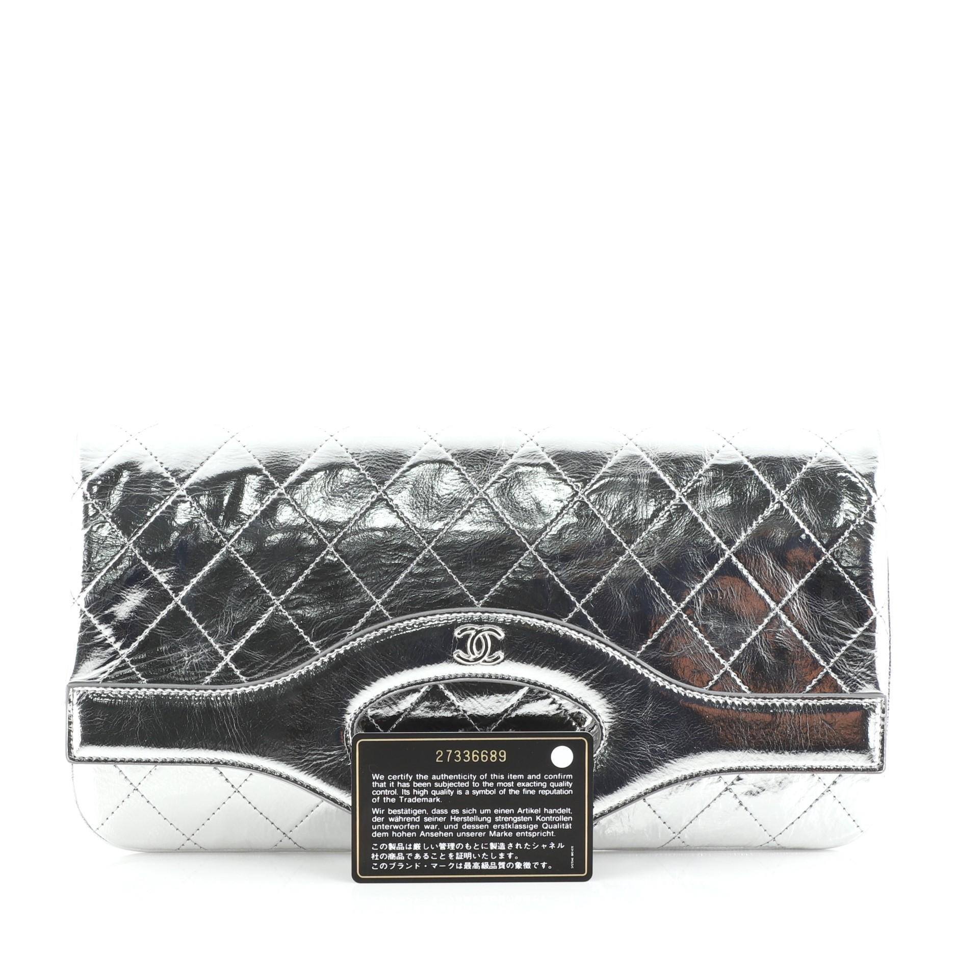 This Chanel 31 Pouch Quilted Metallic Calfskin Medium, crafted in silver quilted calfskin leather, features cutout leather handles and silver-tone hardware. Its fold-over top opens to a gray fabric interior. Hologram sticker reads: 27336689.