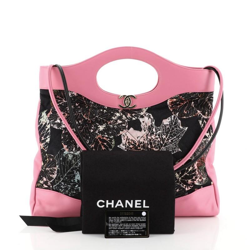 This Chanel 31 Shopping Bag Quilted Printed Cotton and Calfskin Large, crafted in pink quilted printed cotton and pink calfskin, features cutout leather handles, slim leather shoulder straps and gold-tone hardware. Its turn-lock closure opens to a