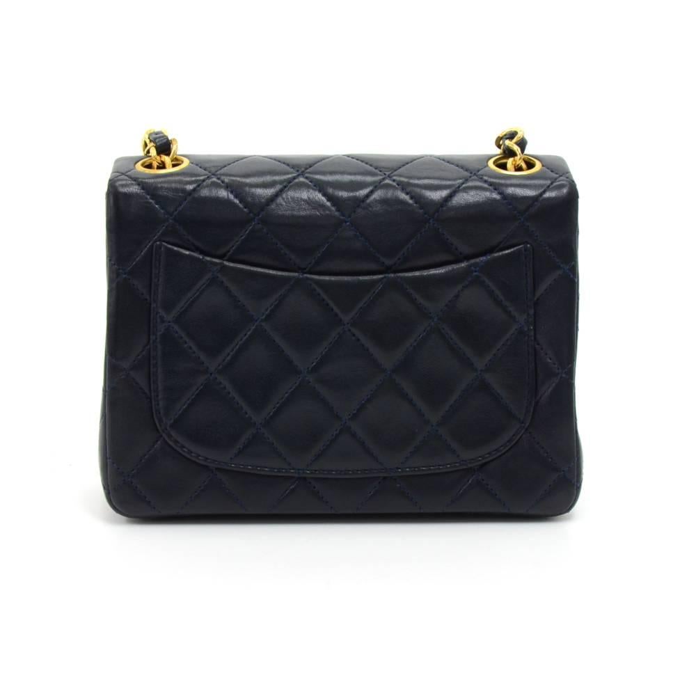 Chanel navy quilted leather mini bag. It has a flap and CC twist lock on the front and open slip in pocket on the back. Inside has Chanel red leather lining and 2 pockets; 1 zipper and 1 open. It can be used as shoulder bag or across the body. SKU: