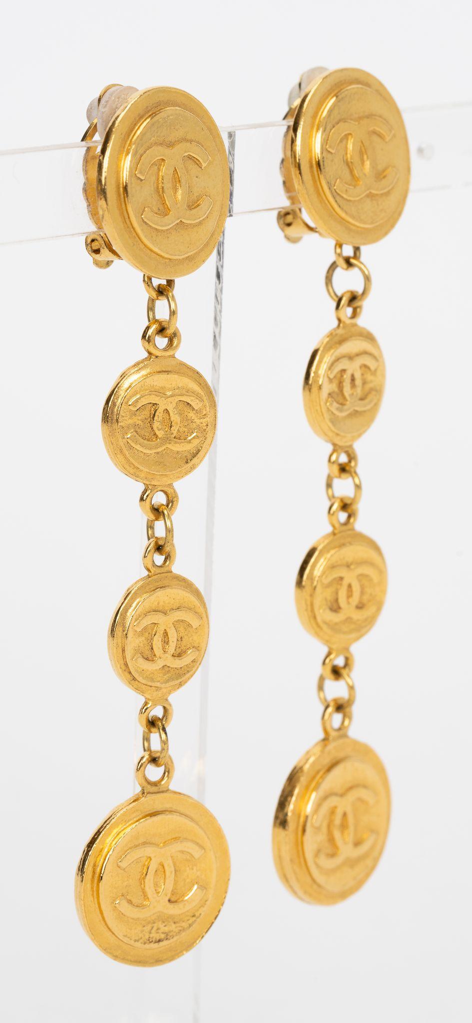 Chanel Vintage Coin Drop Earrings, feature four gold plated coin drops. These iconic Chanel earrings take your from day to evening. Come with original box. 