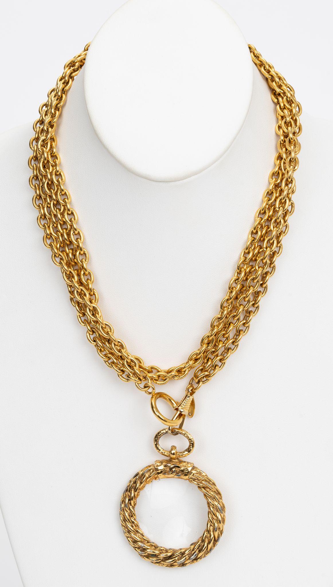 Chanel Cocomark Loupe Necklace is a beautiful long gold plated necklace. Double chain, can be worn long or doubles short.  A definite statement piece. Pendant 2.5” x 2”. Minimum wear on pendant, please refer to photos. Comes with original duster or