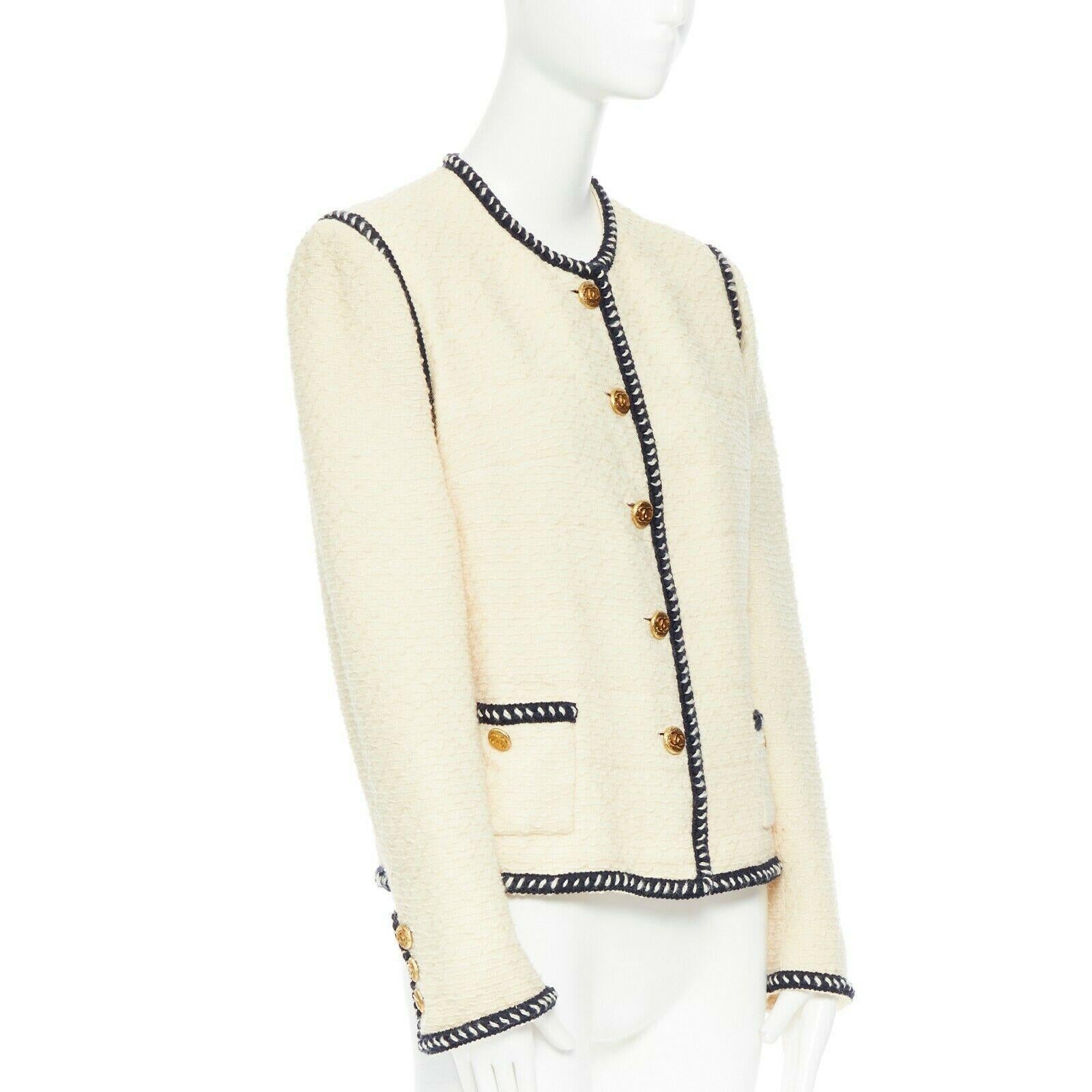 CHANEL 80s vintage ecru tweed navy braid trim gold CC button collarless jacket
Brand: CHANEL
Designer: Karl Lagerfeld
Collection: circa 1980s
Model Name / Style: Tweed jacket
Material: Other; composition label removed. Feels like wool.
Color: