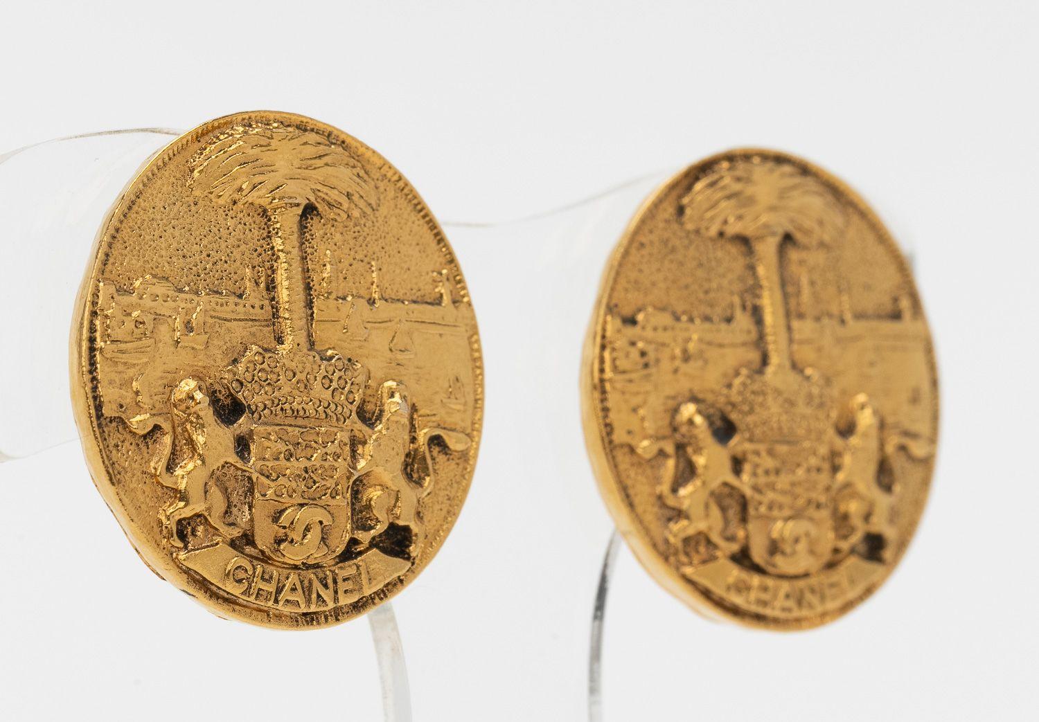 Chanel Vintage Clip Ons in Gold featuring a picture of two lions around a tree and a Chanel signature. In excellent condition.