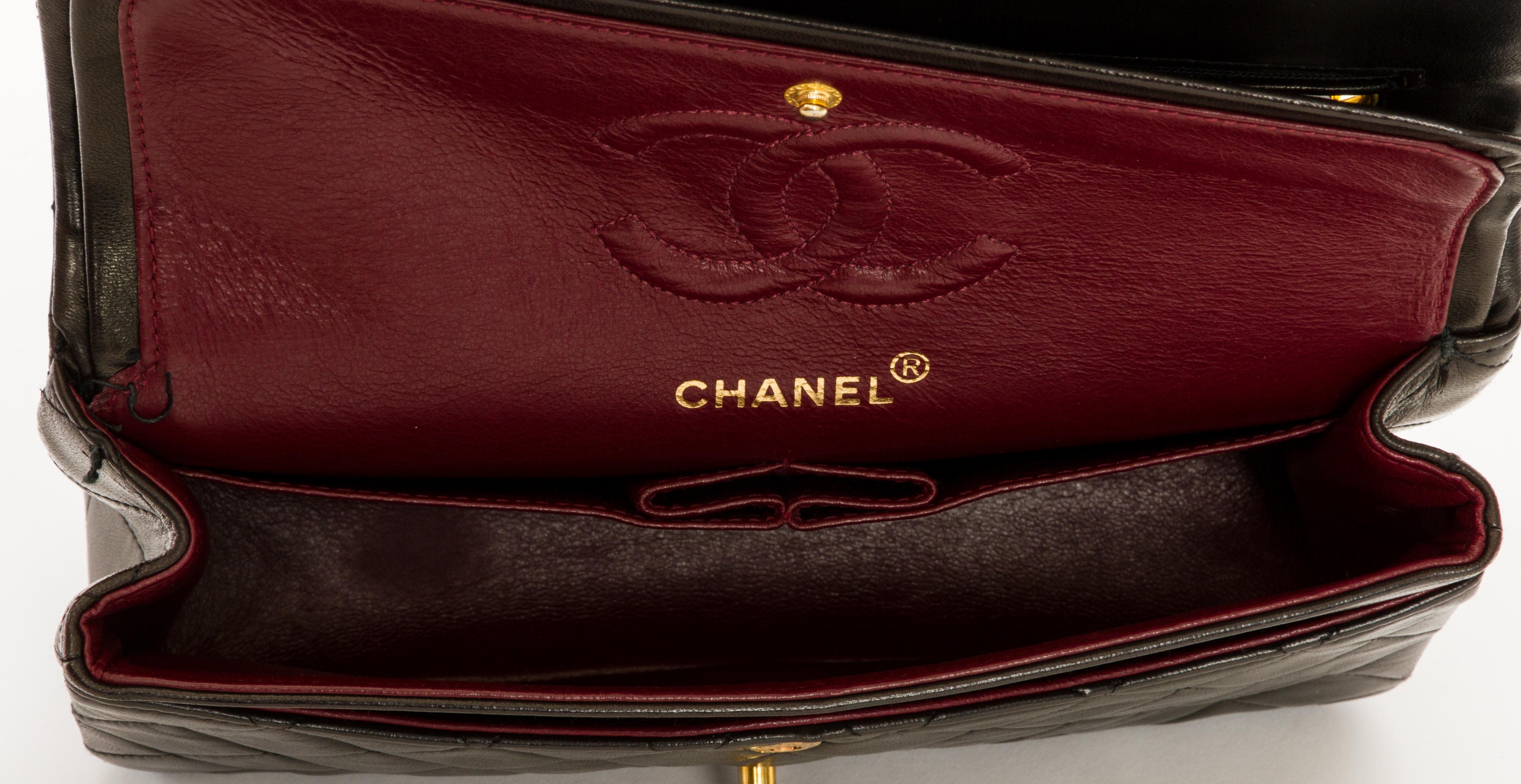 Chanel black classic double-flap lambskin 2.55 bag. Can be worn two ways: Shoulder drop, 17.5