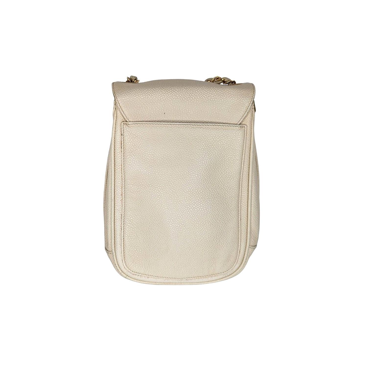 This striking bag is crafted of grained calfskin leather in light beige and features an oversized 24K plated gold CC turn-lock closure, single exterior patch pocket and a lengthy chain-link threaded strap. The flap opens to a spacious beige leather