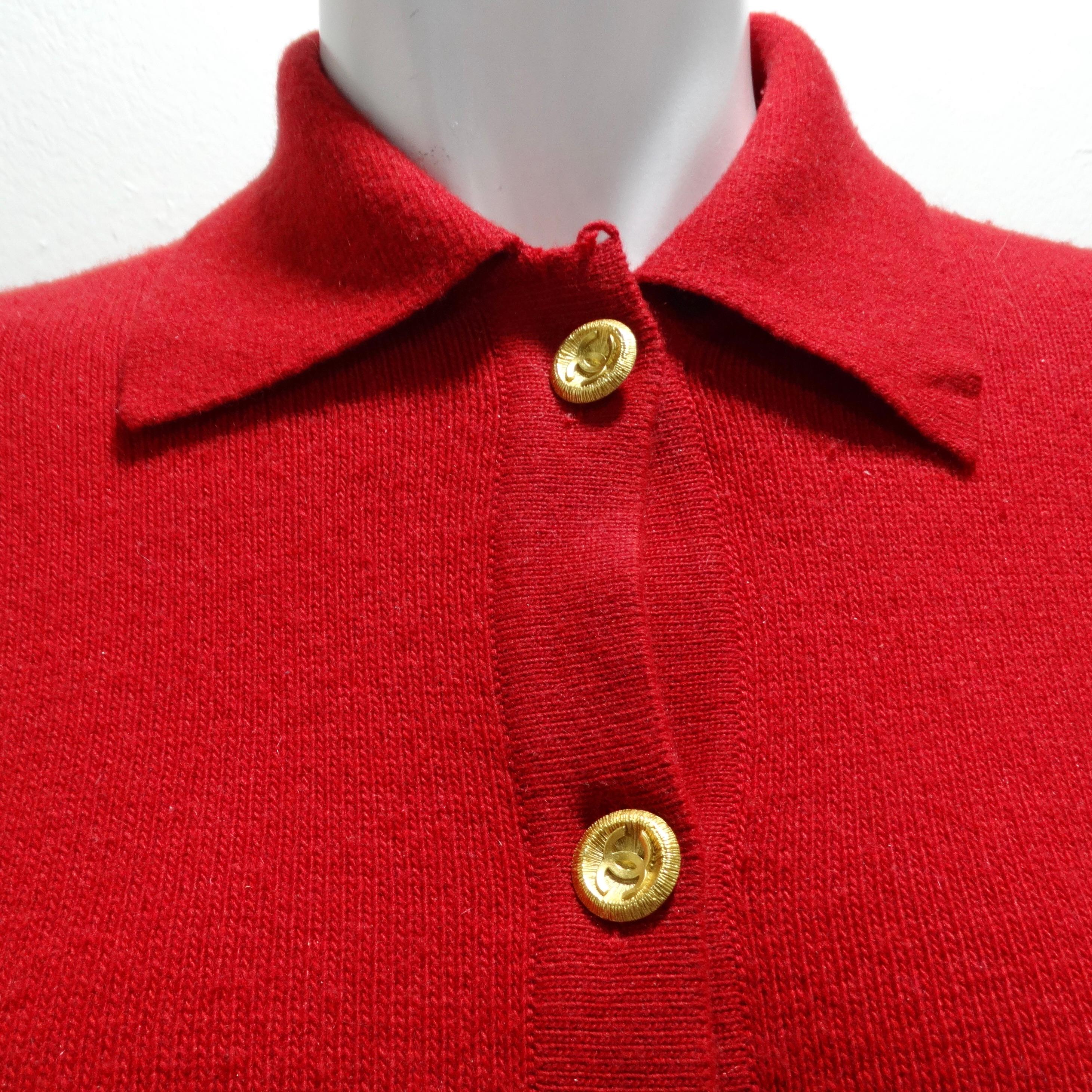 Indulge in luxury with the Chanel 90s Red Cashmere Cardigan. This thick cashmere button-up cardigan boasts a collar, two central pockets, and a plethora of shiny yellow gold-tone buttons, each adorned with the iconic CC logo. A vibrant statement