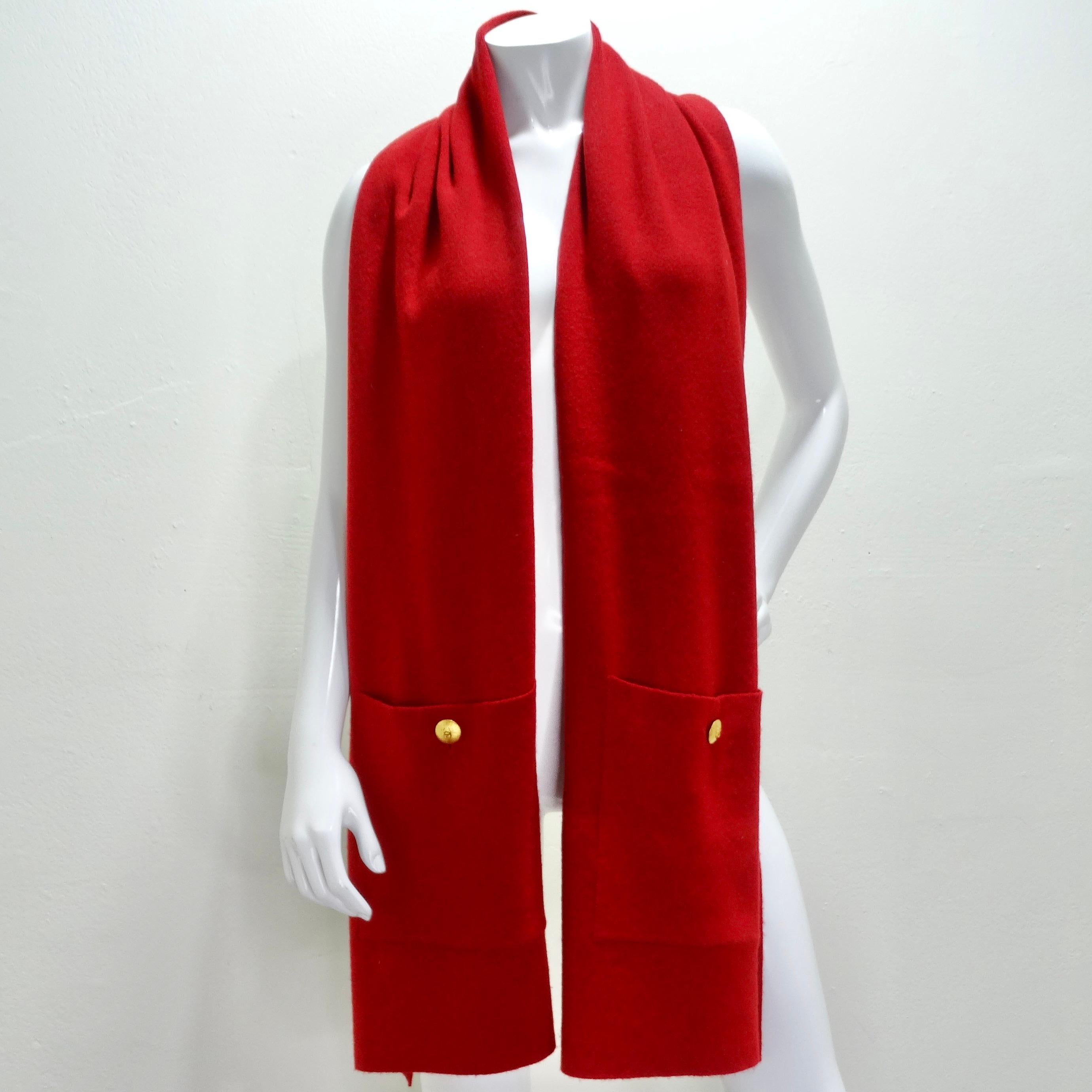 Wrap yourself in luxury with the Chanel 90s Red Cashmere Pocket Scarf. Crafted from incredibly soft cashmere, this thick scarf is not only a stylish accessory but also a functional must-have for the coldest climates. The large pockets at both ends,