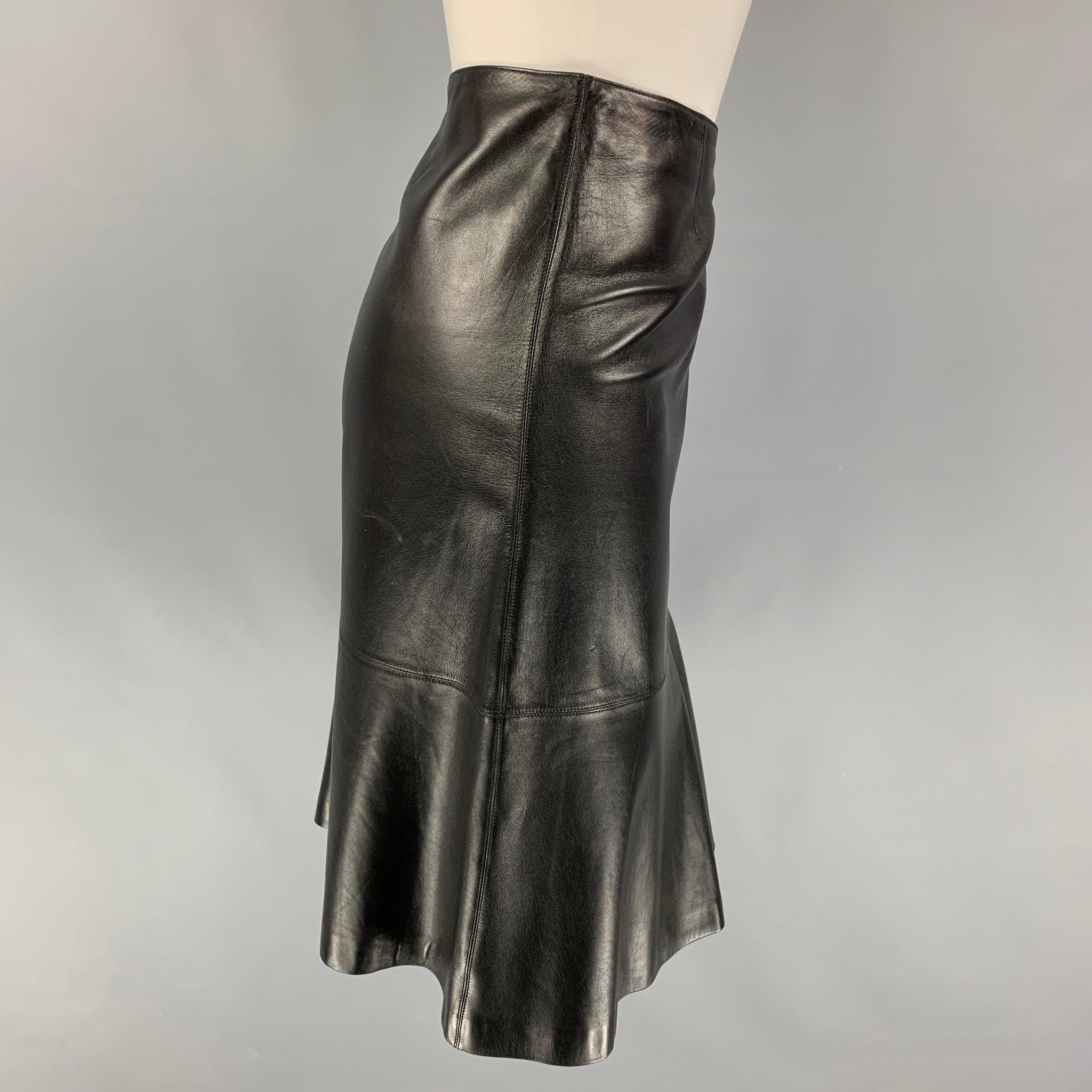 CHANEL skirt comes in a black leather featuring a trumpet style, logo emblem, and a back zip up closure. Made in France.
Very Good
Pre-Owned Condition. 

Marked:   94305 04A / 38 

Measurements: 
  Waist: 29 inches  Hip: 37 inches  Length: 22 inches