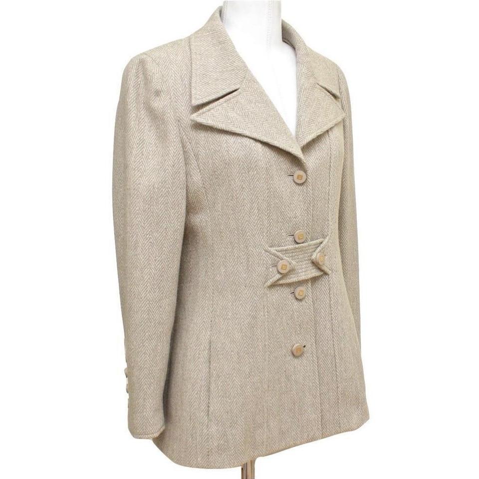 GUARANTEED AUTHENTIC CLASSIC VINTAGE CHANEL WOOL BLEND BLAZER
Collector's Piece!

• Design:
  - Single breasted 4 button stunning fit jacket.
  - Beautiful in a light beige and cream.
  - Vertical slash pockets.
  - Front and rear of jacket there is