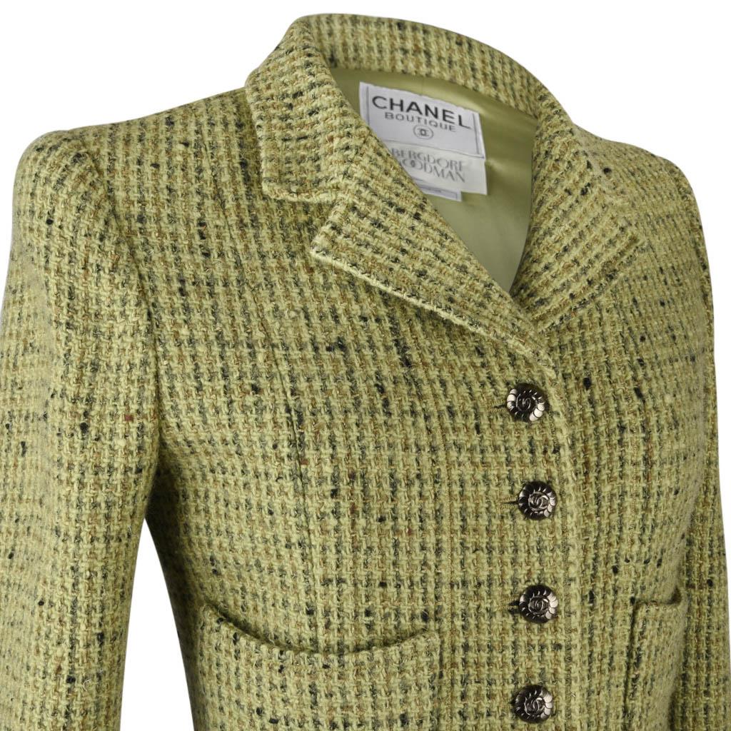 Guaranteed authentic Chanel Tweed jacket 97A features fresh green tweed.
5 button single breast.
Sprinkles of taupe and black create the tweed.
Each cuff has 3 working buttons. 
All buttons are gunmetal beautifully detailed with a center CC.
4