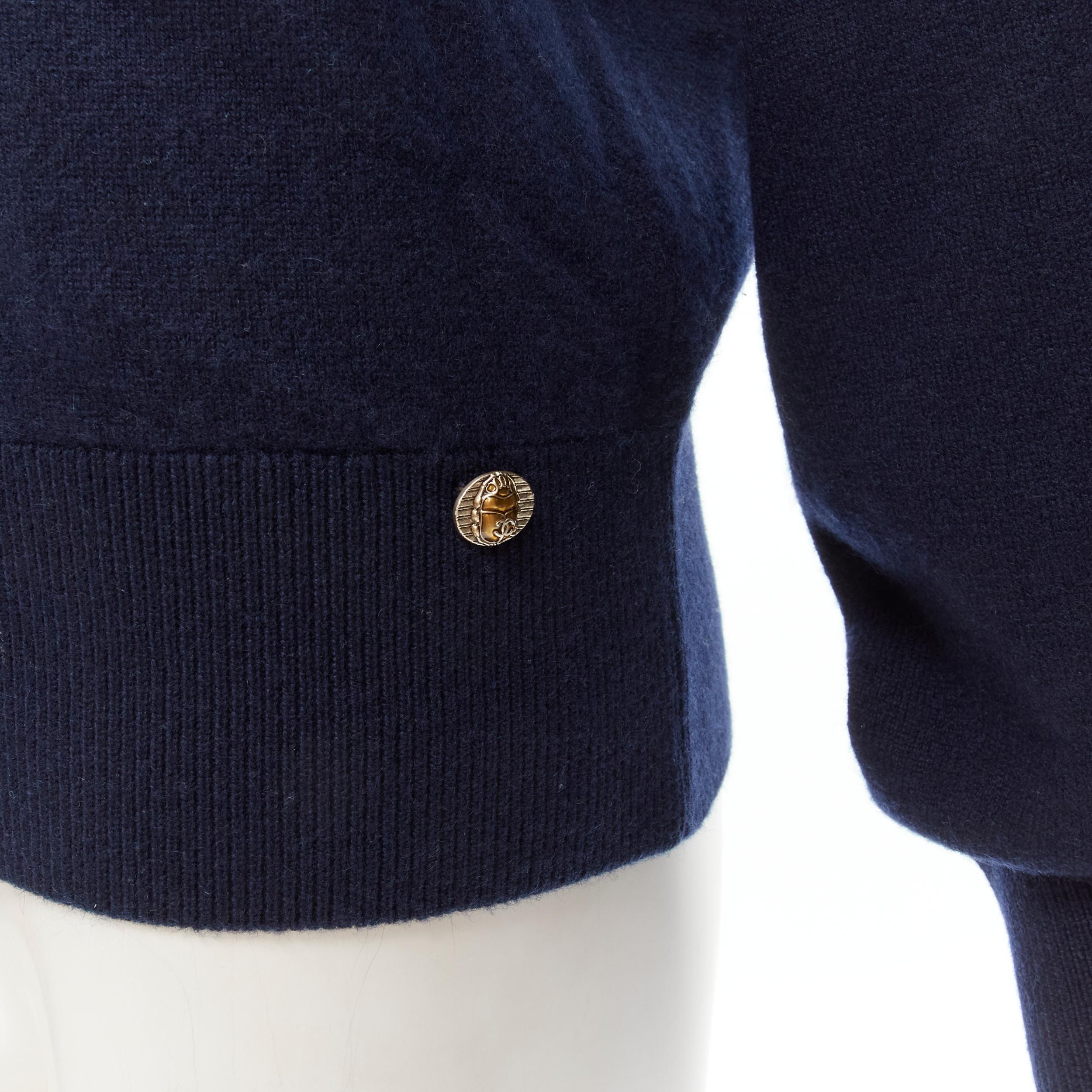 CHANEL 98% cashmere blend navy gold Egypt Hieroglypic pullover sweater FR36 S
Brand: Chanel
Material: Cashmere
Color: Navy
Pattern: Solid
Extra Detail: Gold-tone Scarab CC charm at front hem.
Made in: United Kingdom

CONDITION:
Condition: Excellent,