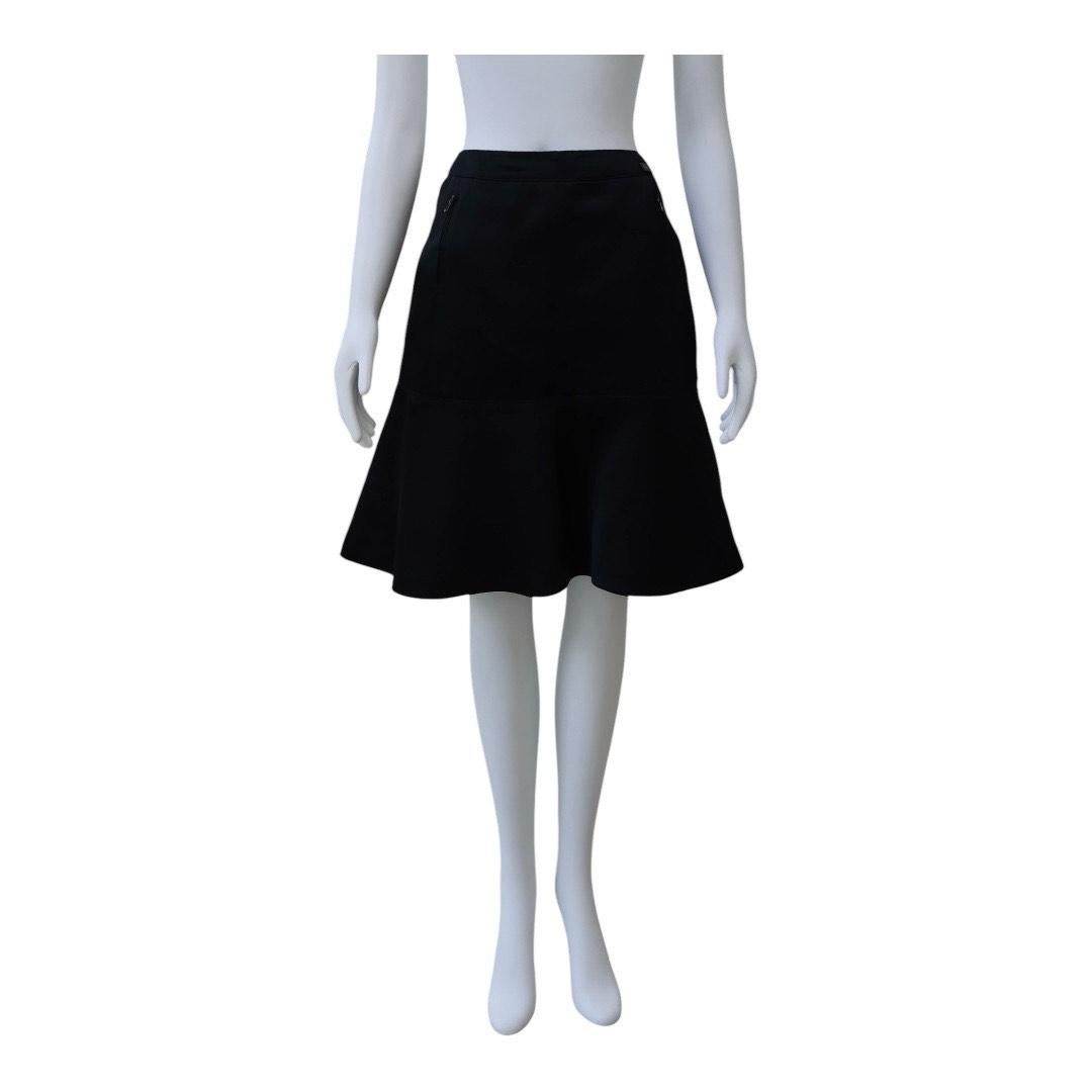 CHANEL Black Silk A-Line Skirt with Flounced Hem
Elevated and versatile, this CHANEL black A-line skirt is crafted from luxe silk with a soft drape and structured silhouette. Designed to sit high on the waist, it features subtle seam detailing and a