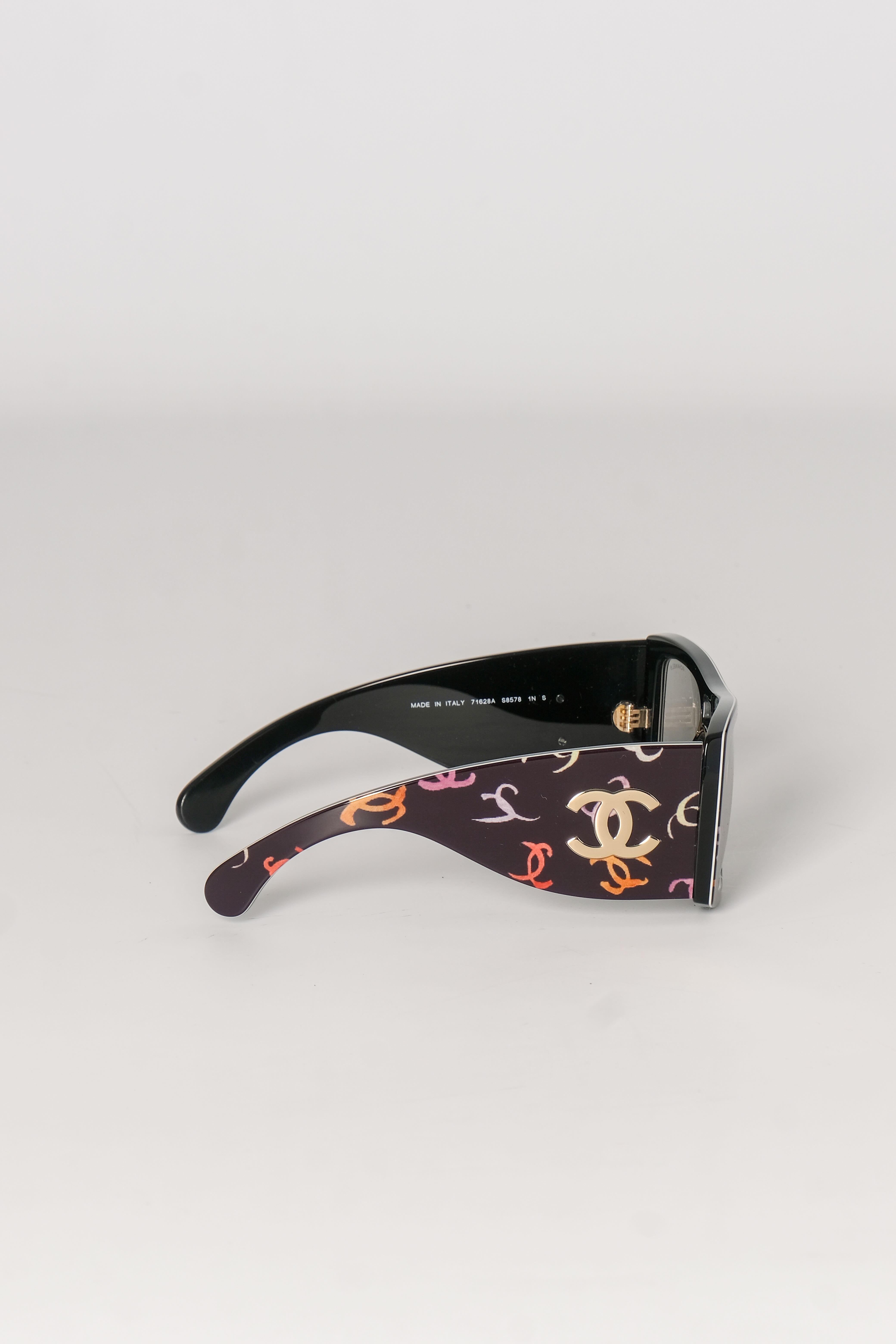 These stunning black sunglasses feature squared frames, squared rims, a dark lenses and is finished with the CC logo printed throughout the acetate frames. The hardware color is champagne gold and they feature the CC logo on each arm.  Designer
