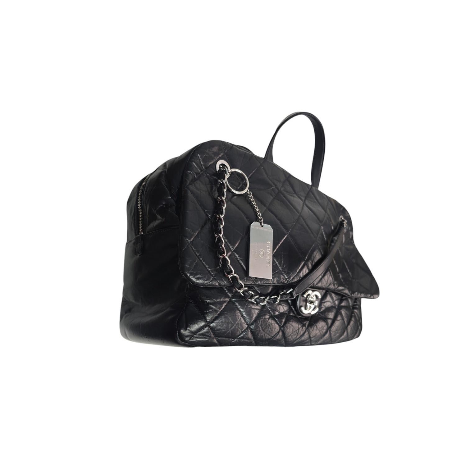 Indulge in luxury with the Chanel Aged Calfskin Quilted Express Bowling Bag. Crafted with black calfskin quilted leather and silver-tone hardware, this tote boasts top handles, chain-link shoulder straps, and multiple compartments for organization.