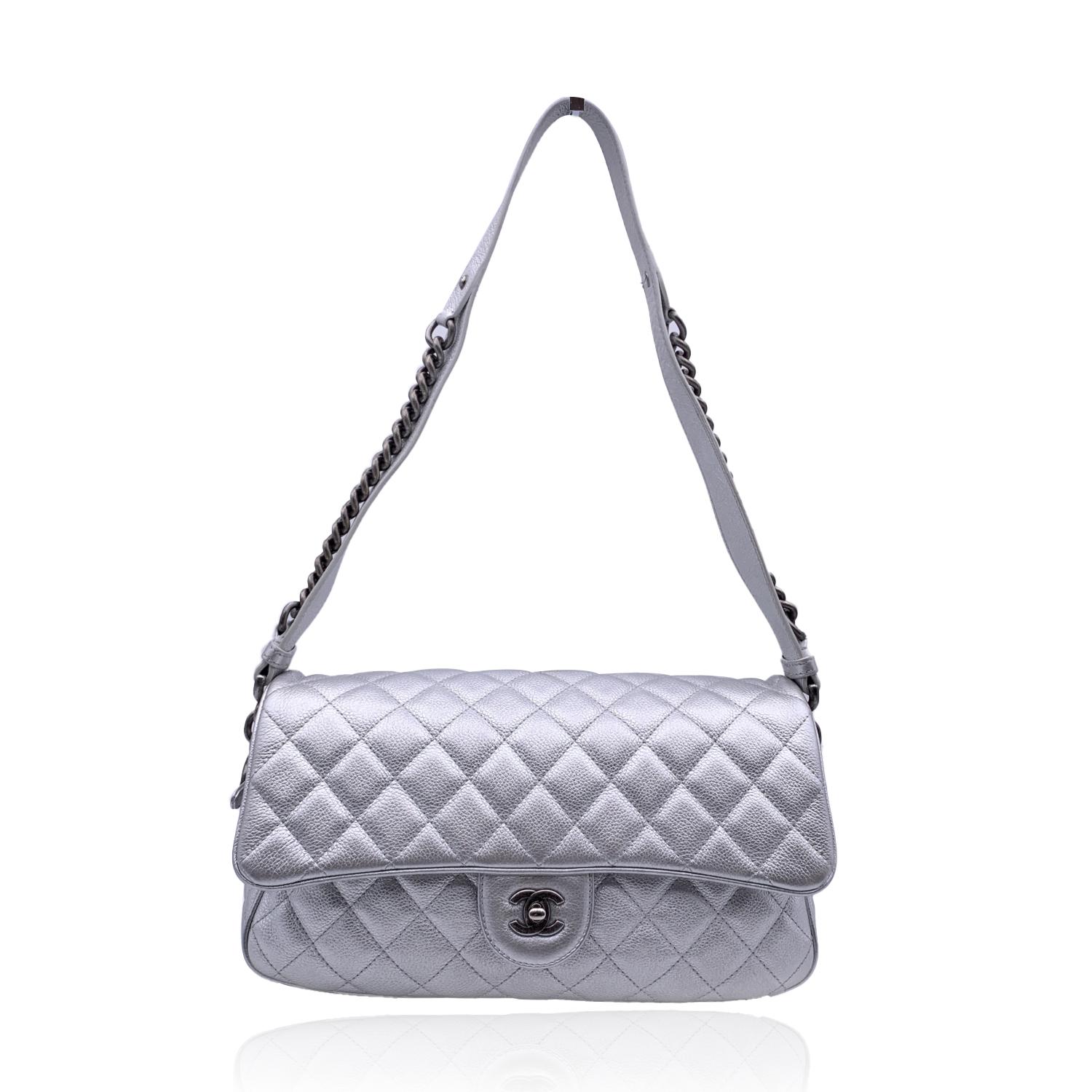 Chanel Limited Edition 'Easy Flap' Shoulder bag from the 2016 'Airline' collection in silver metal quilted leather. Silver metal hardware. Flap with CC logo turn lock closure with upper zipper closure under the flap. Grey fabric lining with 1 side