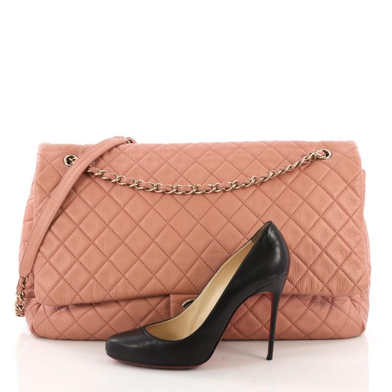 This Chanel Airlines CC Flap Bag Quilted Calfskin XXL, crafted in peach quilted calfskin, features a woven-in leather chain strap with shoulder pad, exterior back pocket and gold-tone hardware. Its CC turn-lock closure opens to a black fabric
