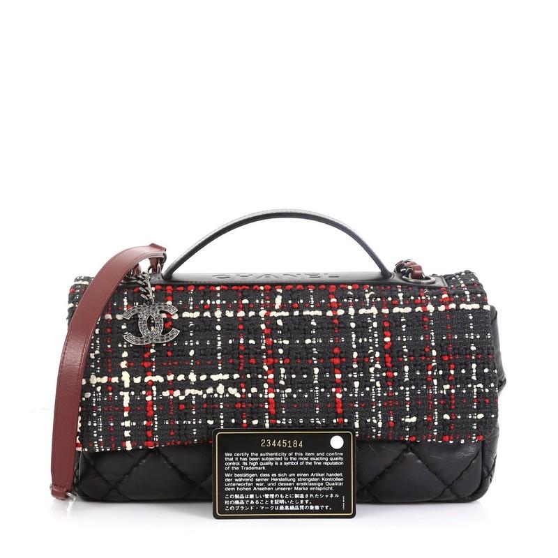 This Chanel Airlines Top Handle Flap Bag Tweed and Quilted Aged Calfskin Medium, crafted in black quilted calfskin and multicolor tweed, features a leather top handle, woven-in leather chain strap, and aged silver-tone hardware. Its CC turn-lock