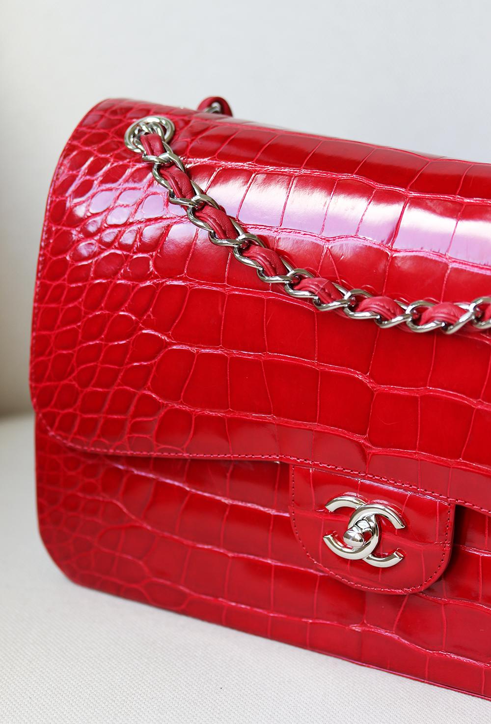 Chanel Alligator Jumbo Classic Double Flap Bag has been hand-finished by skilled artisans in the label's workshop.
Boasting vibrant red alligator leather exterior, this design is accented with silver-toned and red lambskin-leather chain strap.
Made